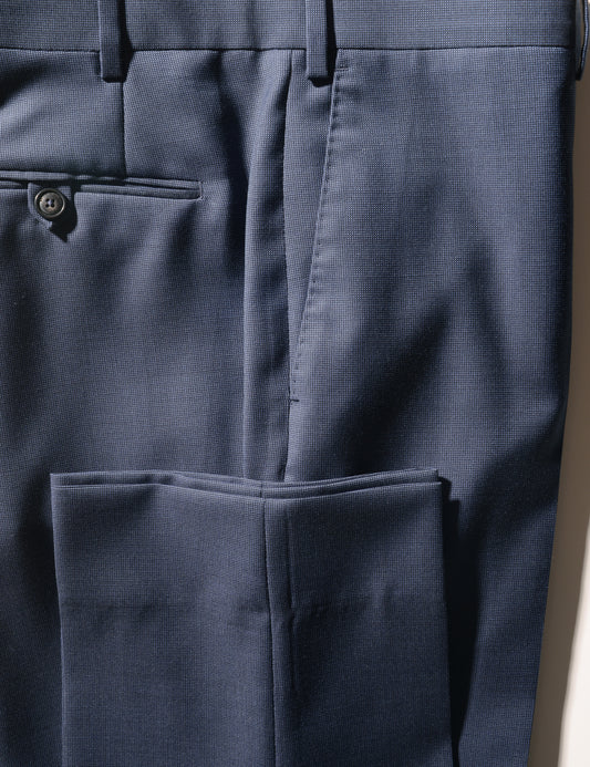 Detail of BKT50 Tailored Trousers in Tick Weave - Mid Blue showing back pocket, side pocket, hem, and fabric texture