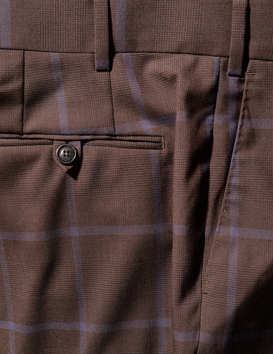 Detail photo of the trouser, showing fabric color, pattern, and also the button and pocket details