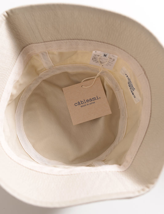Interior shot of Cableami Organic Cotton Herringbone Bucket Hat - Ivory showing labels, taping, and tag