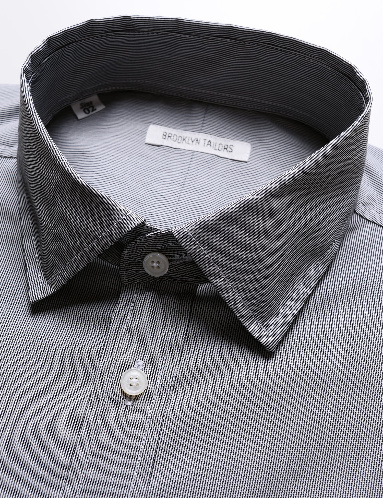 Detail shot of collar, buttons, and fabric pattern on Brooklyn Tailors BKT20 Slim Dress Shirt in Hairline Stripe - Granite