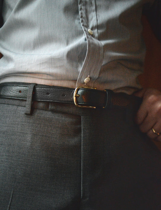 Photo on body of Brooklyn Tailors x Saddler's 25mm Belt in Grain Leather - Black. The model is wearing a dress shirt and suit trousers with the belt.