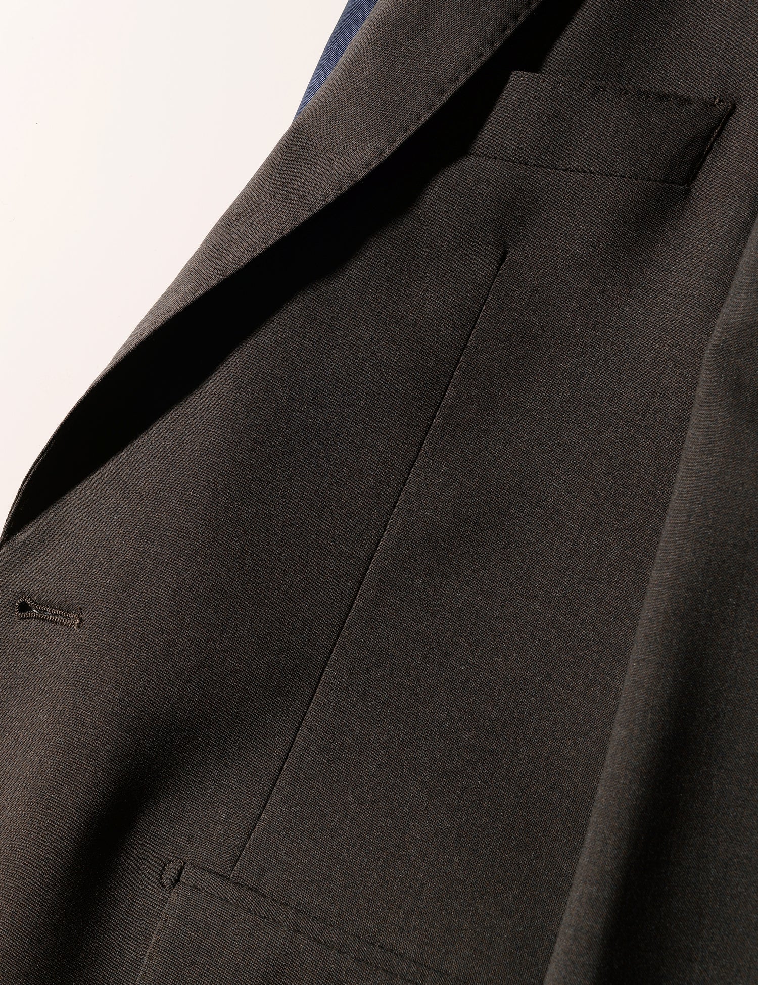 Detail shot of Brooklyn Tailors BKT50 Tailored Jacket in Heathered Plainweave - Charred Ember showing lapel, chest, and pocket