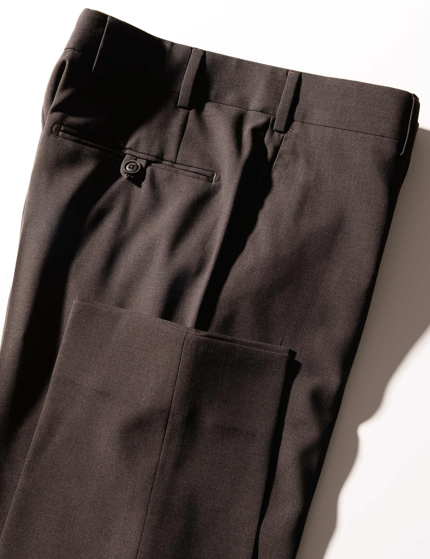 Detail shot of Brooklyn Tailors BKT50 Tailored Trousers in Heathered Plainweave - Charred Ember showing hem and back pocket