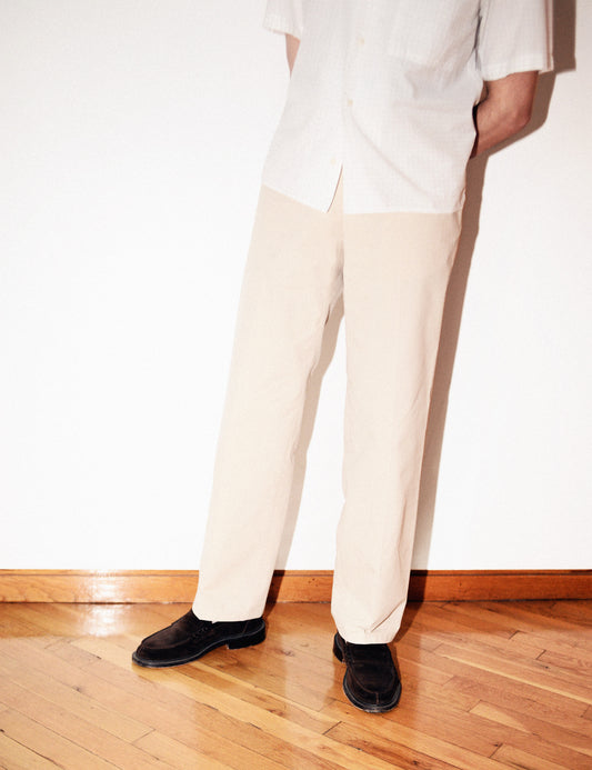 Brooklyn Tailors BKT36 Straight Leg Pant in Crisp Cotton Blend - Desert Sand on-body shot. Model is wearing the pants with a white camp shirt and chocolate brown dress shoes