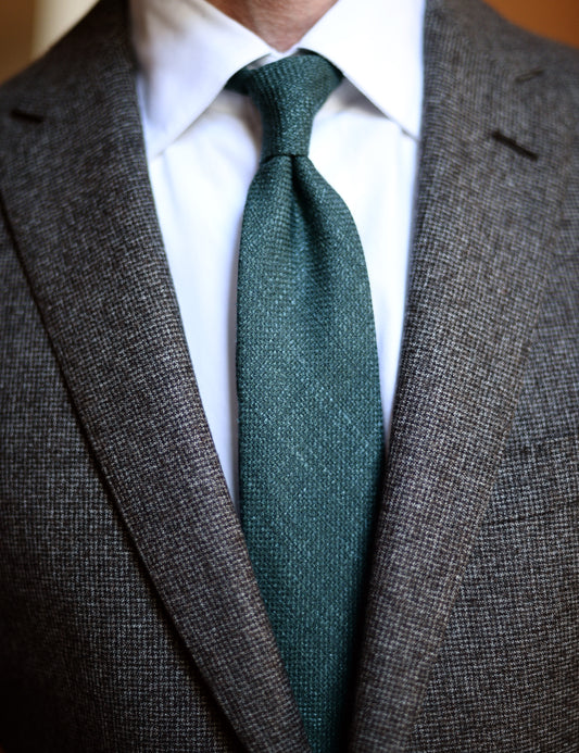 Silk, Wool, and Linen Hopsack Tie - Emerald on body. Model is wearing a suit jacket and white dress shirt.