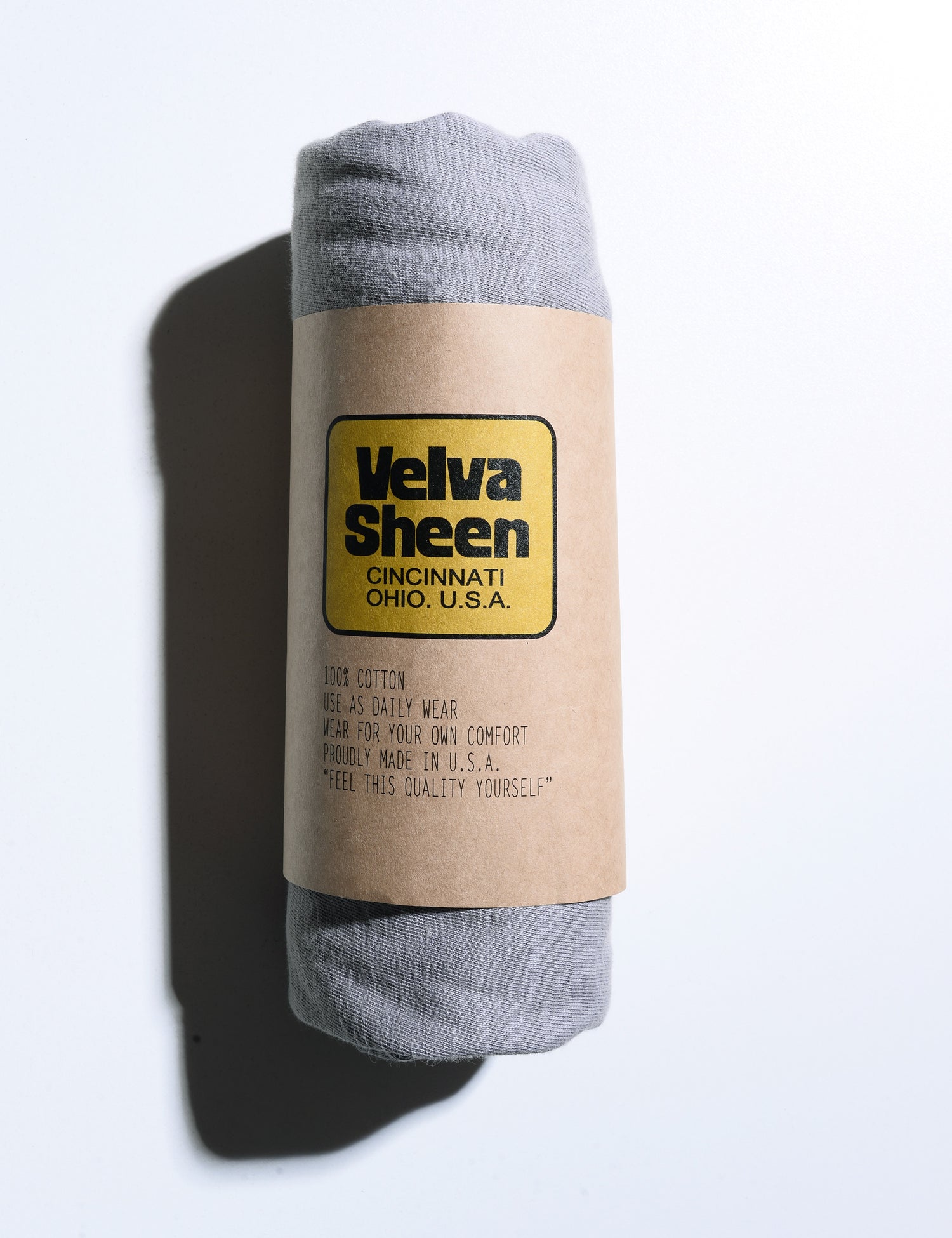 Velva Sheen Long Sleeve Crewneck T-Shirt in Gray rolled in its paper sleeve
