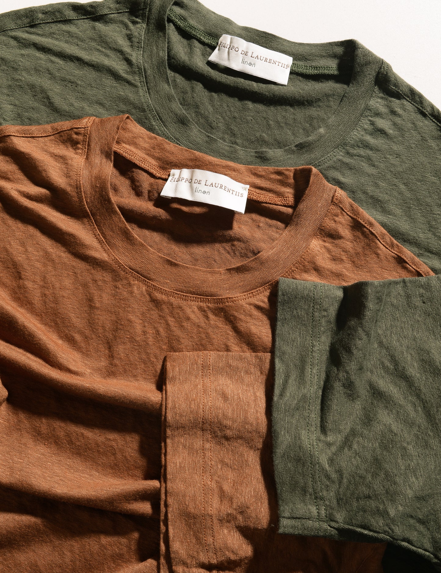 Detail shot of two colors of Filippo de Laurentiis Linen Knit Tees to show colors, neck, and cuffs