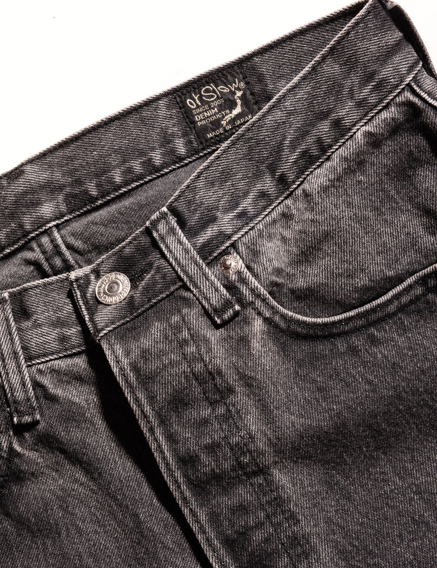 Detail of Orslow 105 Standard Fit '90s Stonewash Jeans - Black showing front button, waistband, and front pocket