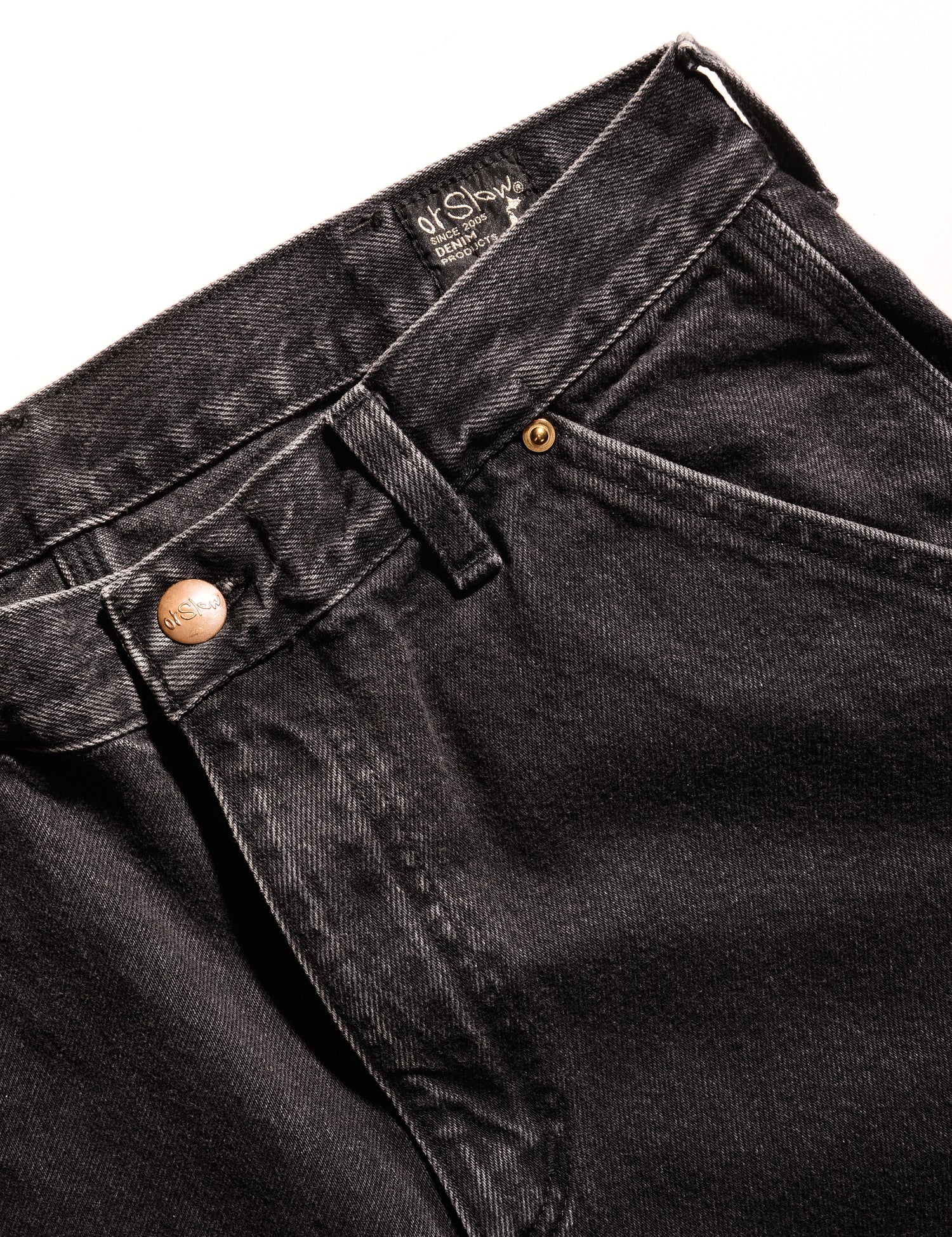 Close-up shot of Orslow Relaxed Fit Painter Pants in Denim - Stonewash Black showing button closure and front pocket