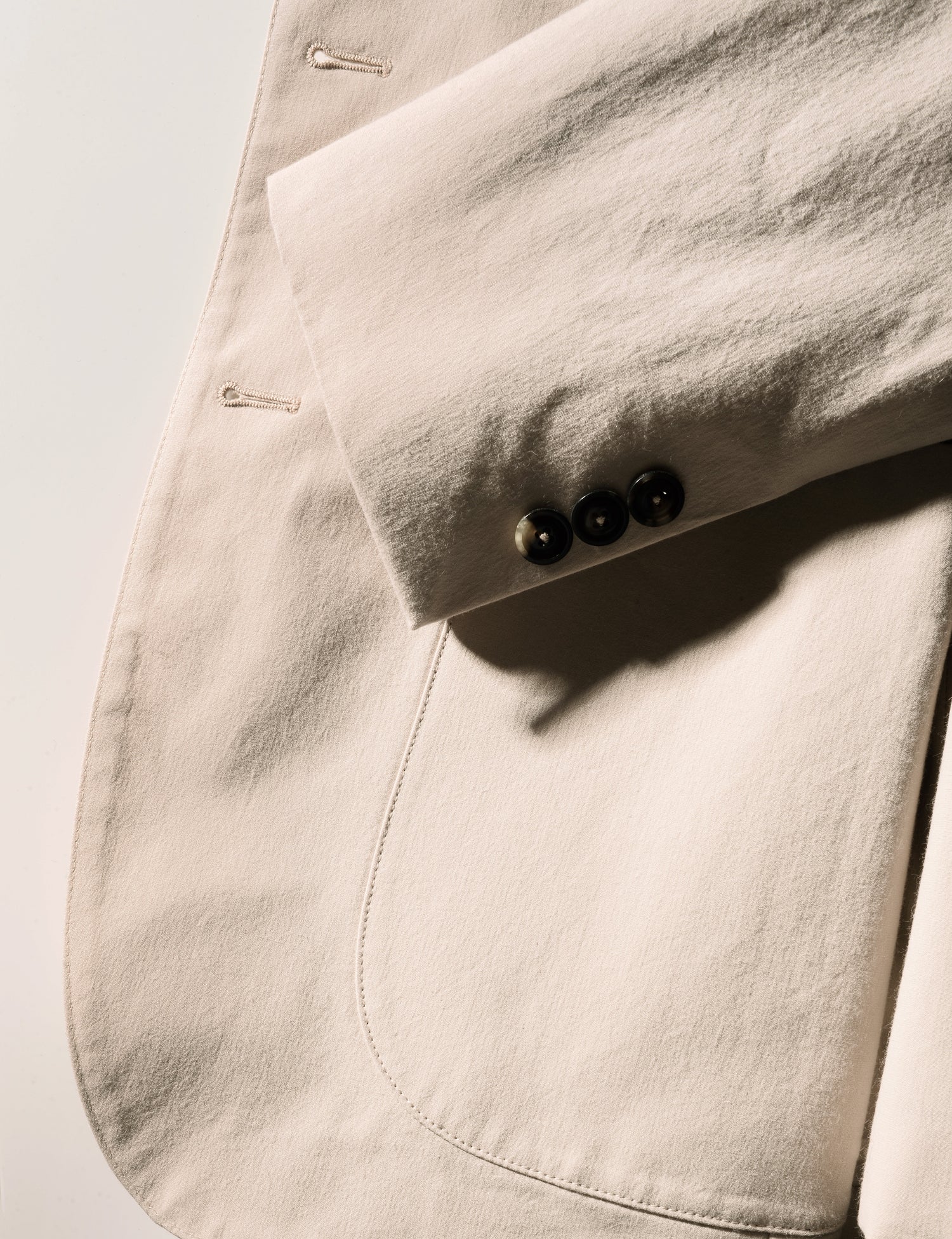 Detail shot of cuff, patch pocket, buttonholes, and fabric texture on Brooklyn Tailors BKT35 Unstructured Jacket in Crisp Cotton Blend - Desert Sand
