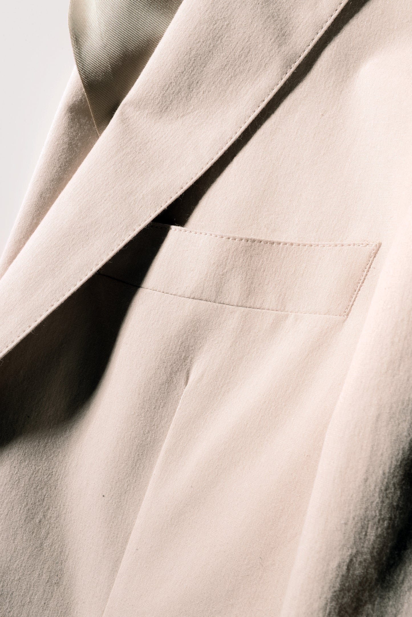 Detail shot of chest pocket and lapel on Brooklyn Tailors BKT35 Unstructured Jacket in Crisp Cotton Blend - Desert Sand