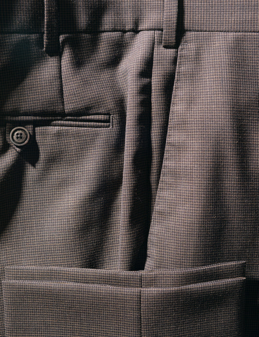 Detail of BKT50 Tailored Trousers in Wool Grid Weave - Iron Oxide showing back pocket, hem, and fabric texture