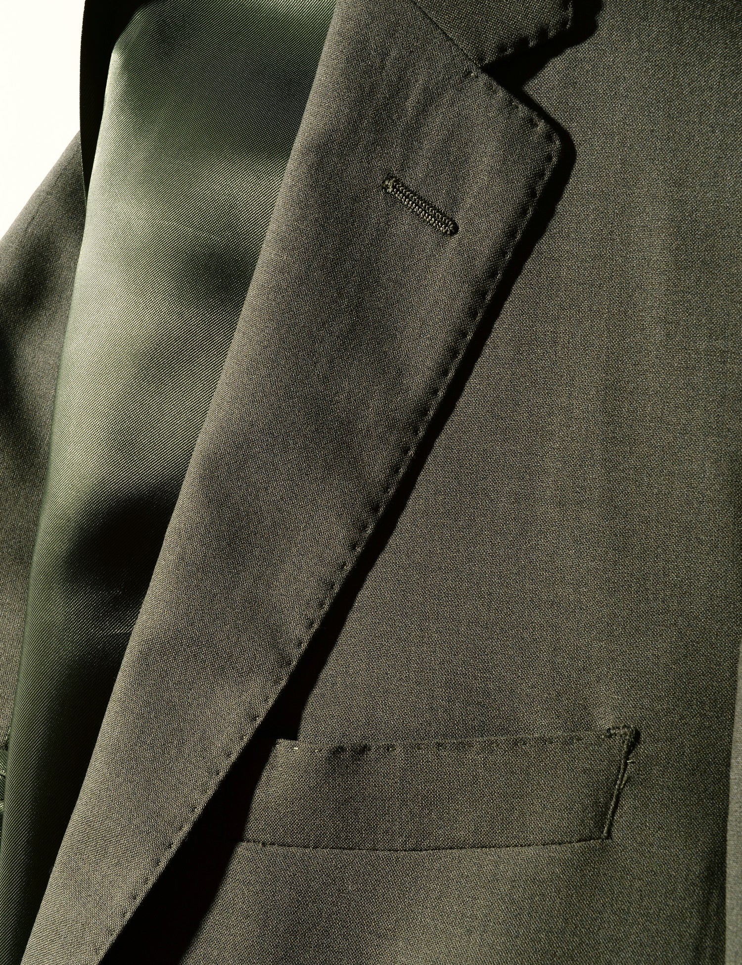 Detail of Brooklyn Tailors BKT50 Tailored Jacket in 14.5 Micron Mouliné - Agave Green showing lapel, pocket, and lining
