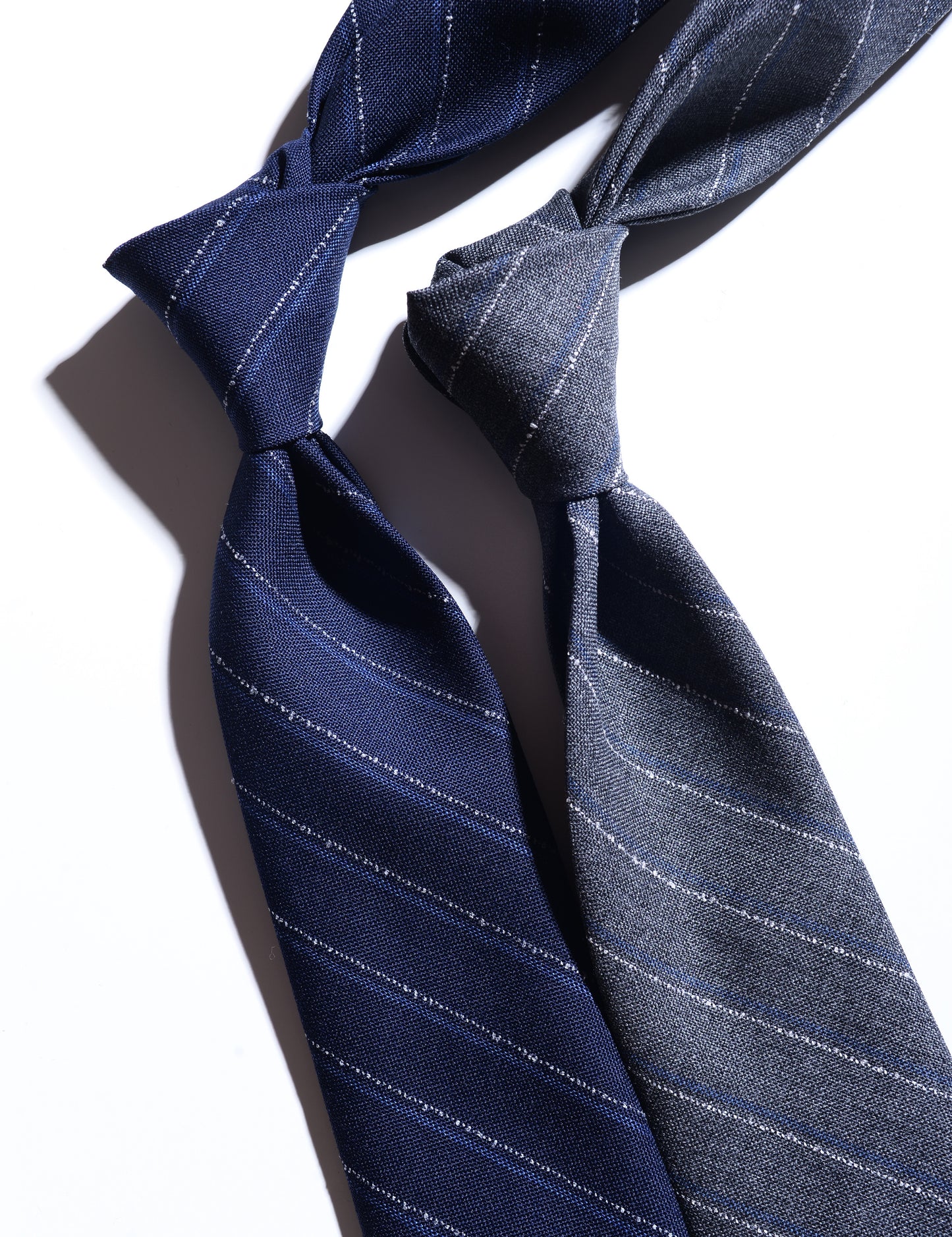 Detail of Untipped Mid-gray with Blue and White Chalkstripe Tie showing fabric texture and pattern
