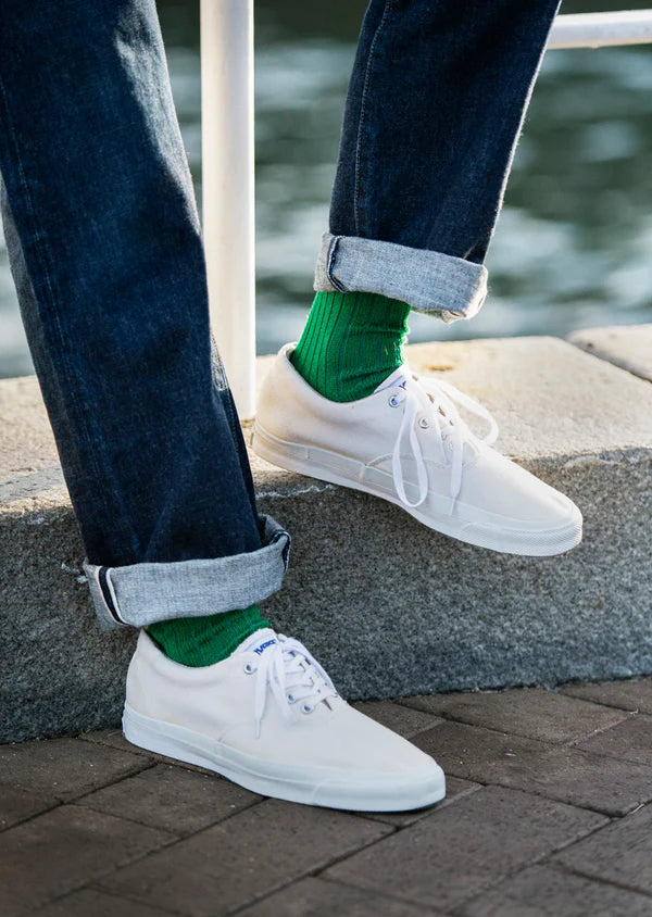 On-body shot of Rototo Cotton Linen Ribbed Crew Socks. Model is wearing socks with jeans and white sneakers