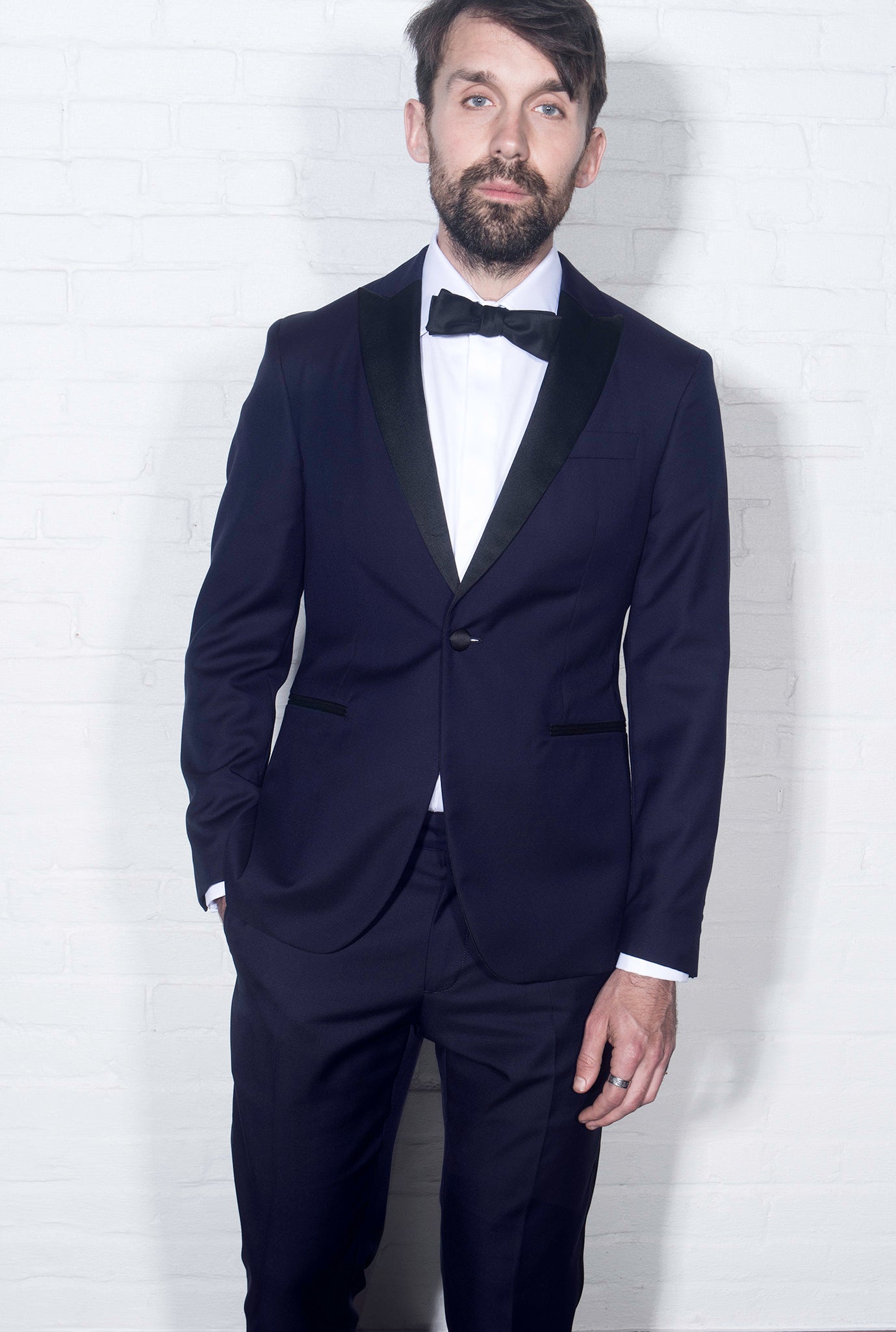 On-body shot of Brooklyn Tailors BKT50 Tuxedo Trouser in Super 110s - Navy with Satin Stripe. Model is wearing trouser with matching jacket, white tuxedo shirt, and black bowtie