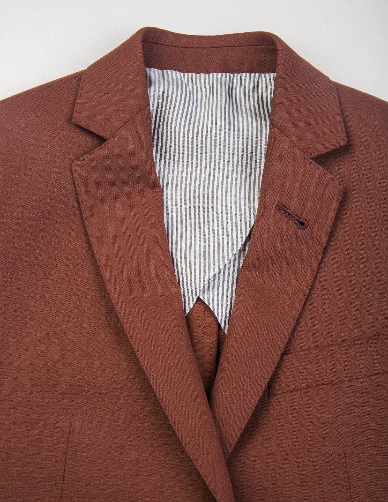 Detail shot of Brooklyn Tailors BKT50 Tailored Jacket in Herringbone Wool/Cotton - Brick showing lapel, and half-lining