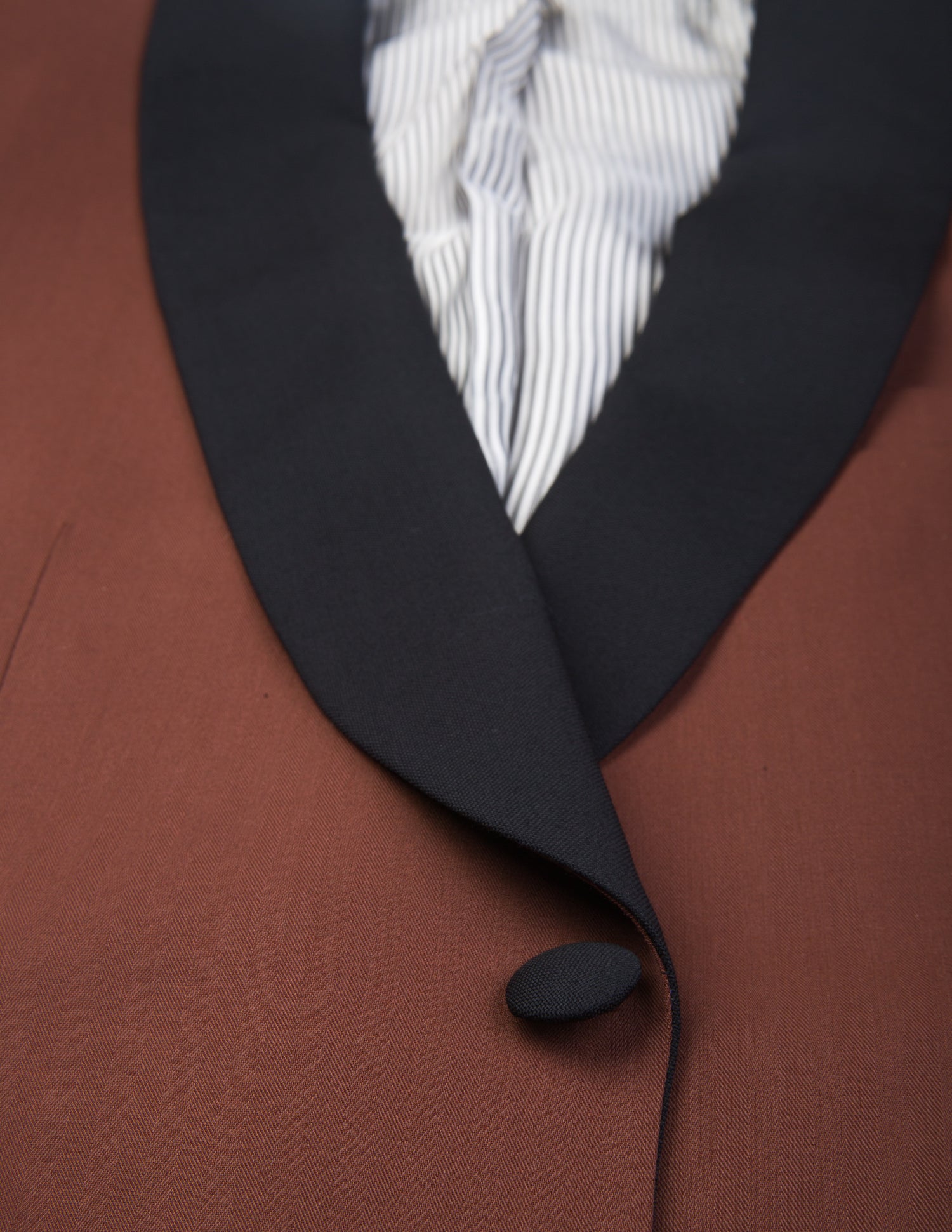 Detail shot of Brooklyn Tailors BKT50 Shawl Collar Dinner Jacket in Herringbone Wool/Cotton - Brick showing lapel, button closure, and lining