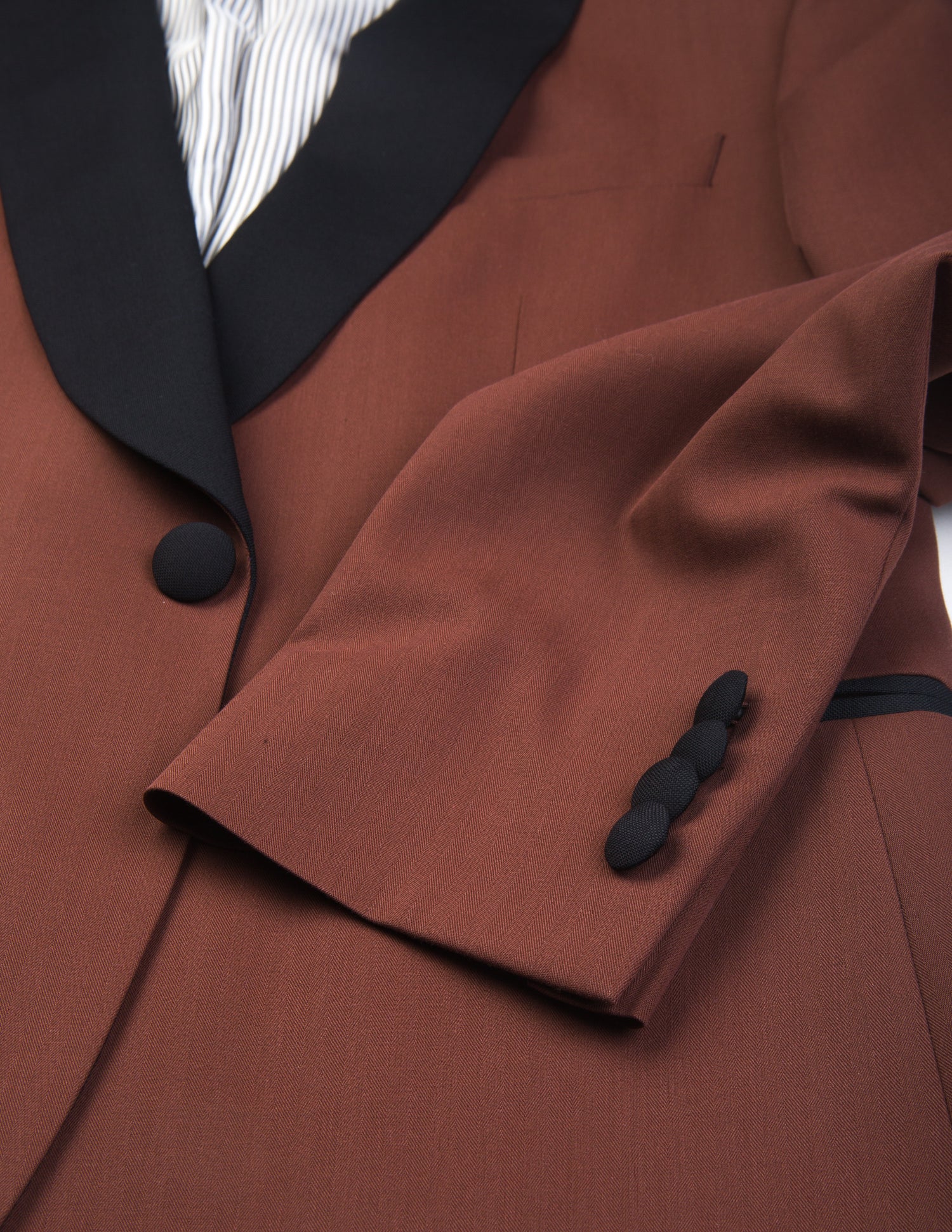 Detail shot of Brooklyn Tailors BKT50 Shawl Collar Dinner Jacket in Herringbone Wool/Cotton - Brick showing lapel, sleeve and button closure