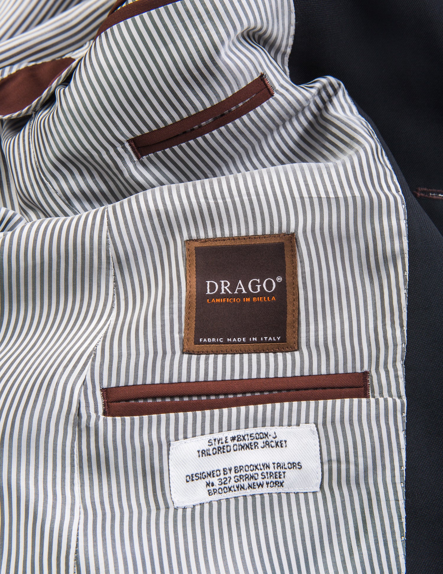 Detail shot of Brooklyn Tailors BKT50 Shawl Collar Dinner Jacket in Herringbone Wool/Cotton - Brick showing Drago label on the interior