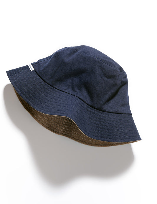 Flat shot of Cableami Reversible Cotton Bucket Hat - Navy/Beige on the navy side