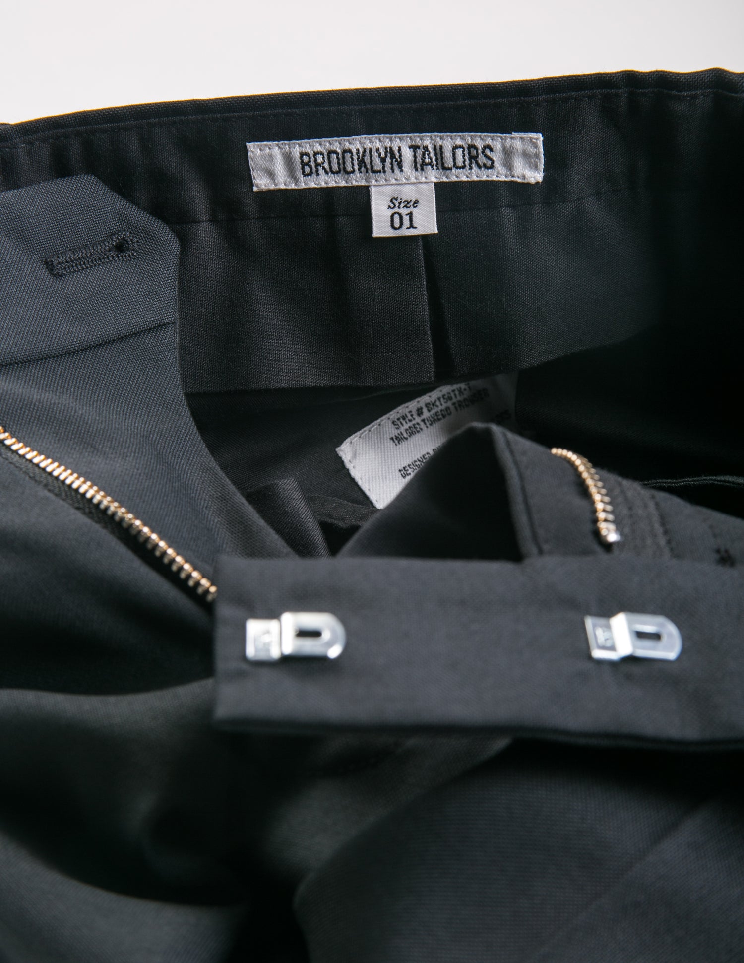 Detail shot of BKT50 Tuxedo Trouser in Super 110s - Black with Grosgrain Stripe showing interior labeling