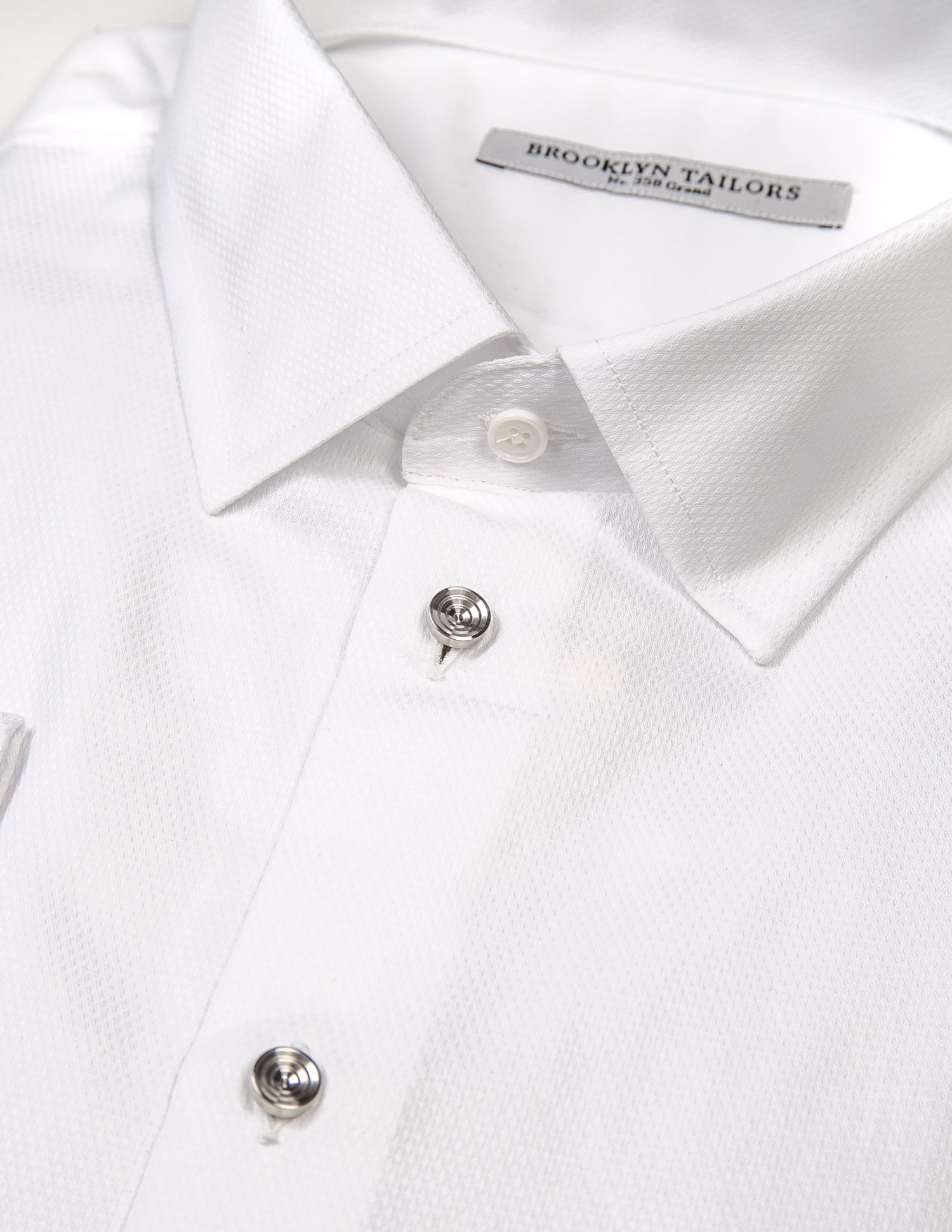 Detail showing Brooklyn Tailors French Cuff Tuxedo Shirt With Removable Buttons - White Dobby with removable buttons out and shirt studs instead