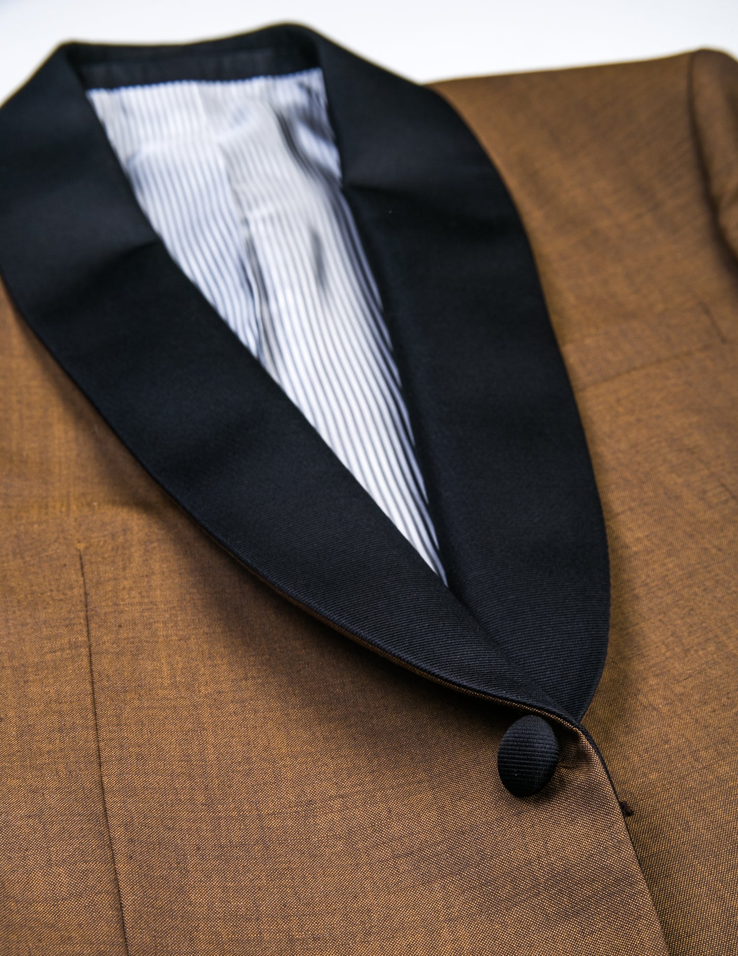 Detail of BKT50 Shawl Collar Dinner Jacket - Copper showing grosgrain lapel and covered buttons