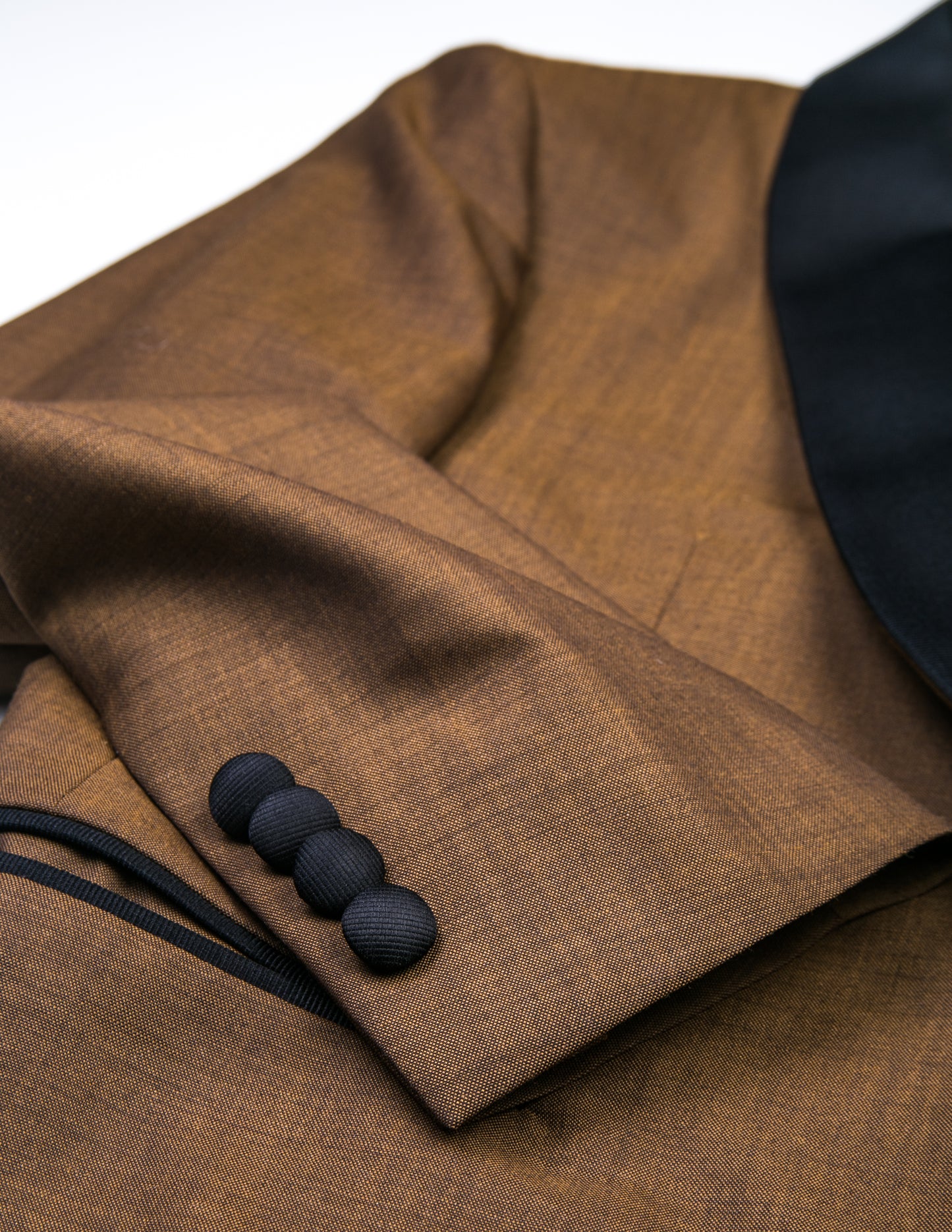 Detail of BKT50 Shawl Collar Dinner Jacket - Copper showing cuff with covered buttons