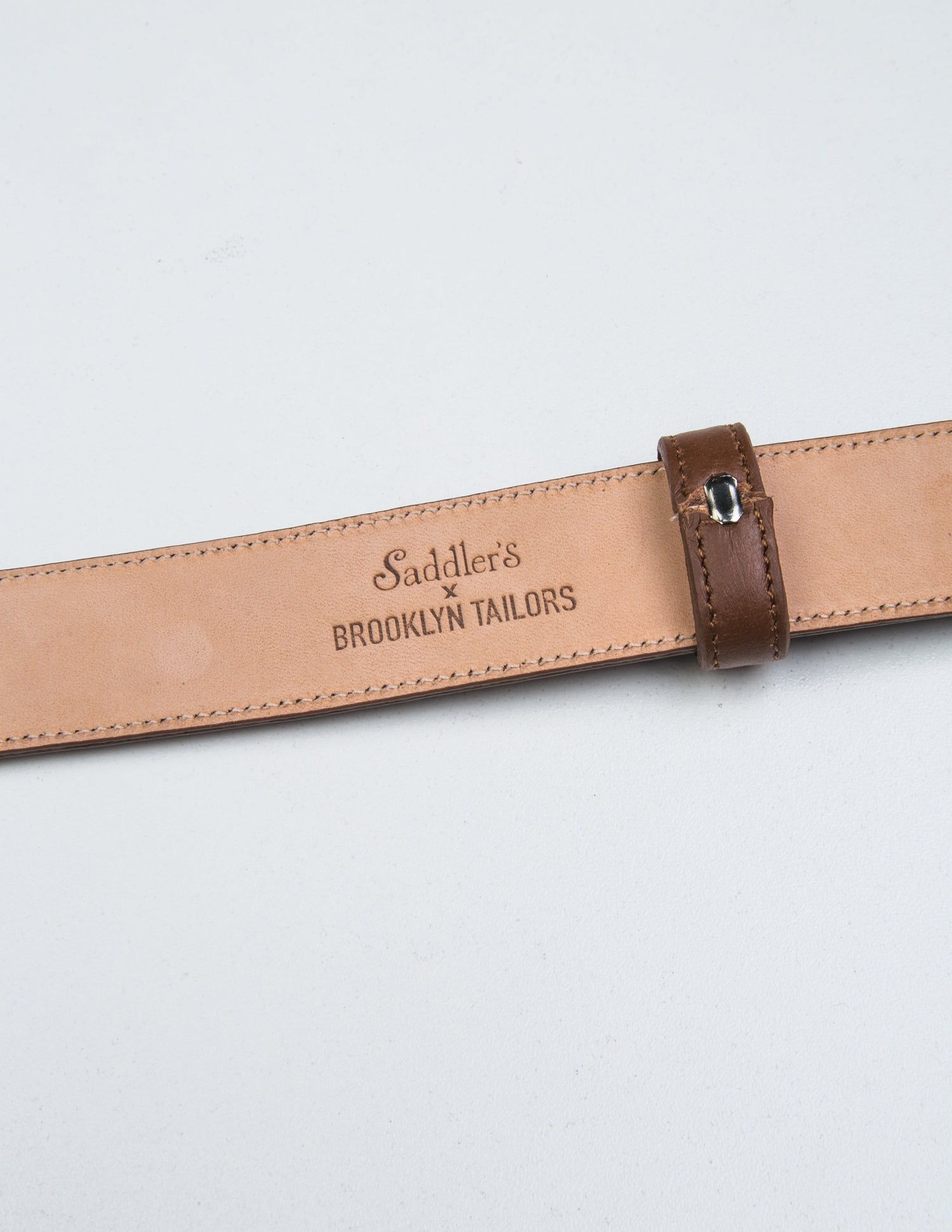 Detail of Saddler's x Brooklyn Tailors stamp on the underside of 30mm Belt in Smooth Leather - Honey Brown