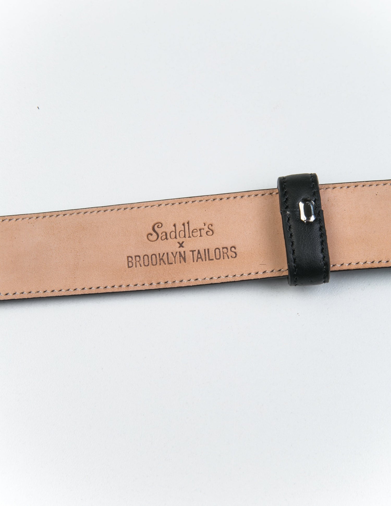 Detail of the Saddler's x Brooklyn Tailors stamp on the underside of 30mm Belt in Smooth Leather - Black