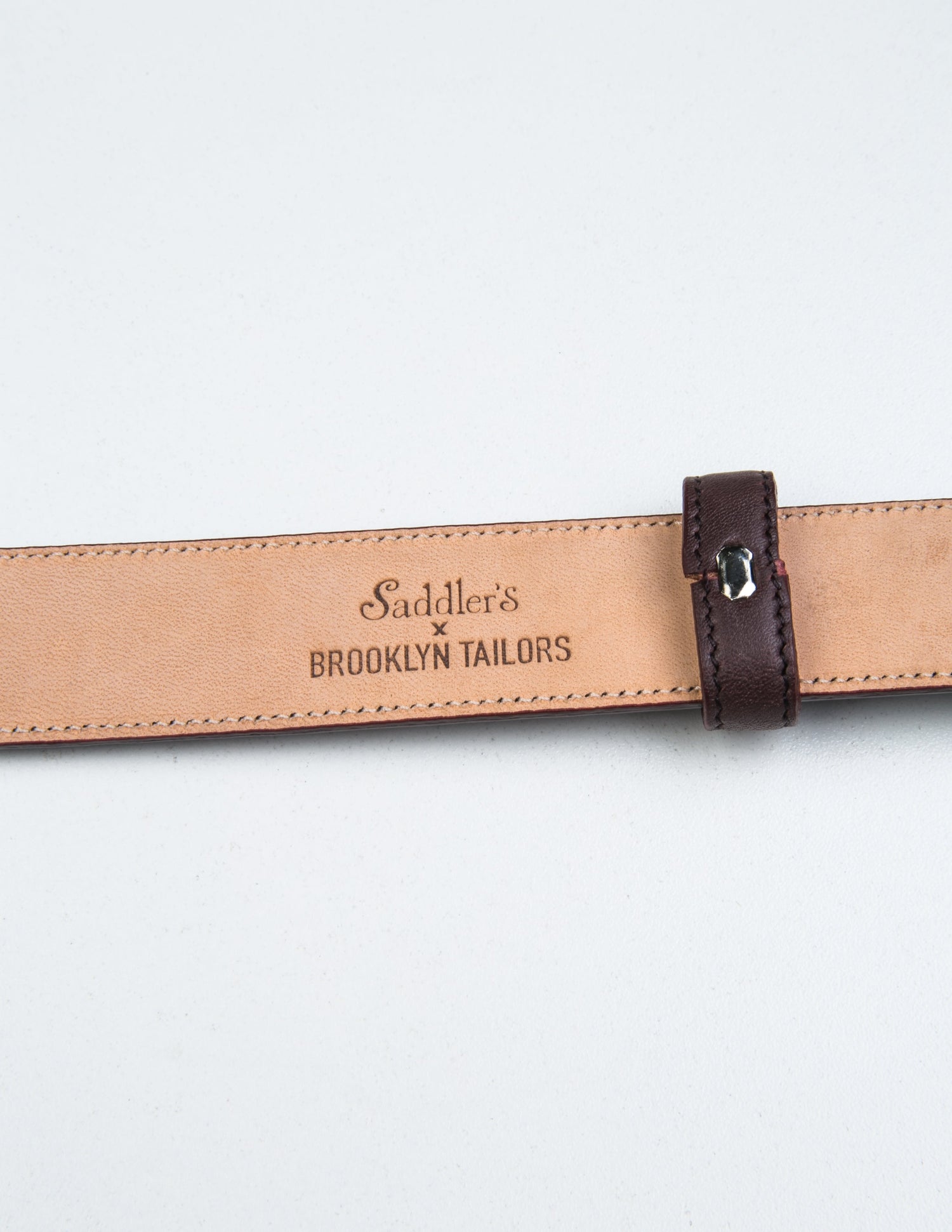 Detail of Saddler's x Brooklyn Tailors stamp on the underside of 30mm Belt in Smooth Leather - Bordo