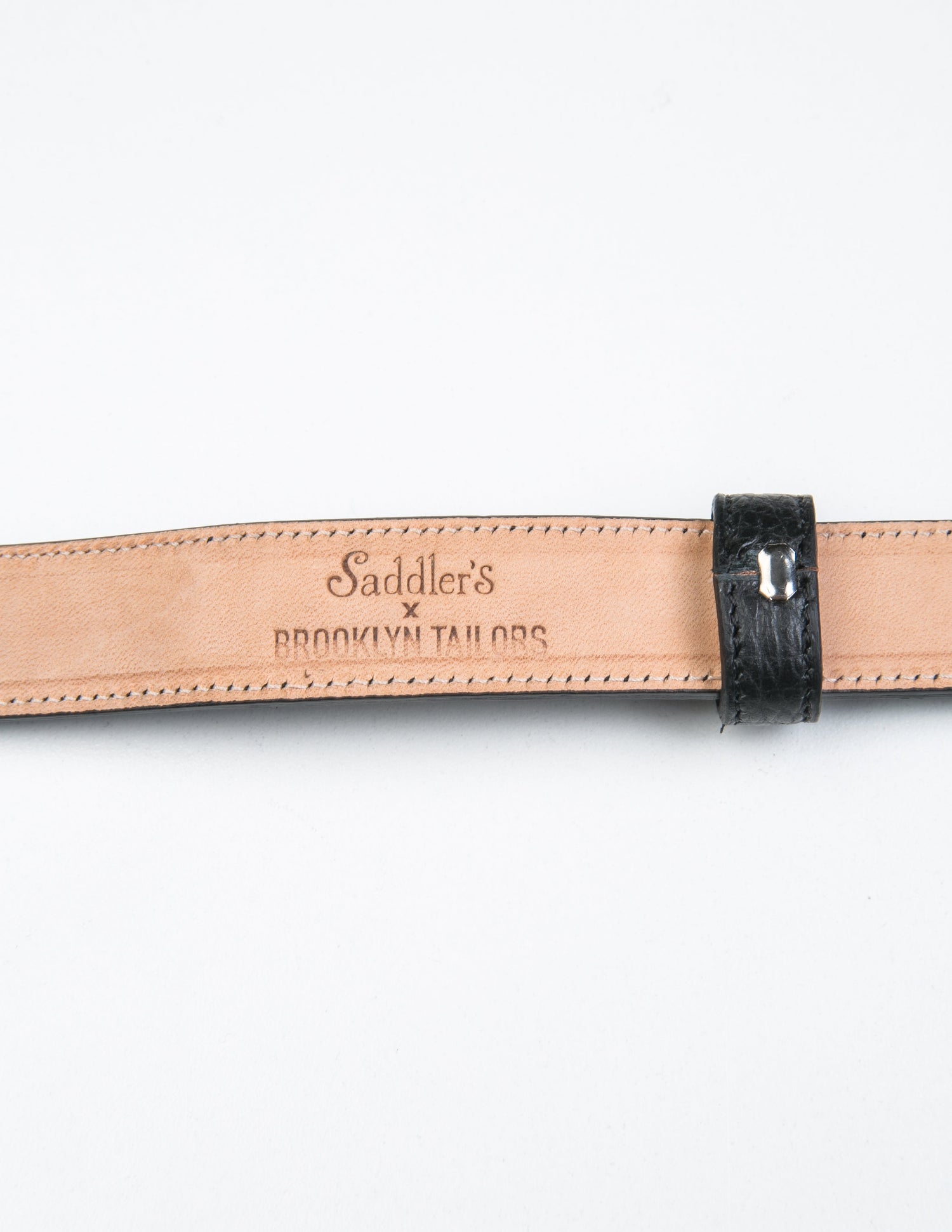 Detail of the Brooklyn Tailors x Saddler's stamp on the underside of the 25mm Belt in Grain Leather - Black