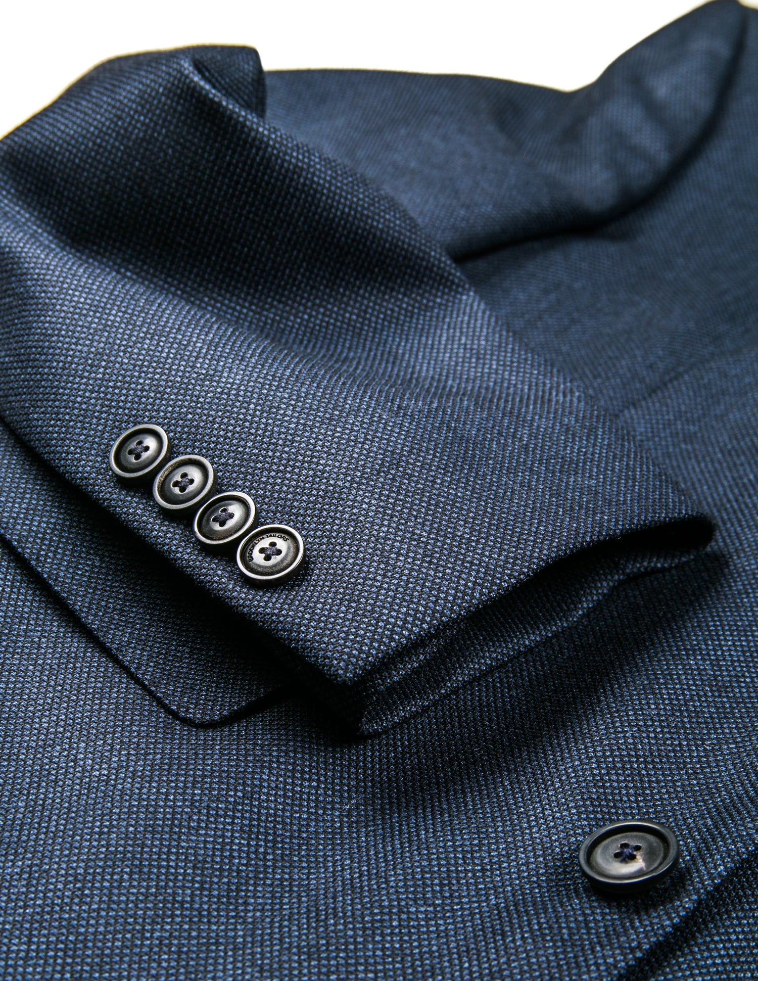 Detail of BKT50 Tailored Jacket in Birdseye Weave - Navy showing cuff and fabric texture