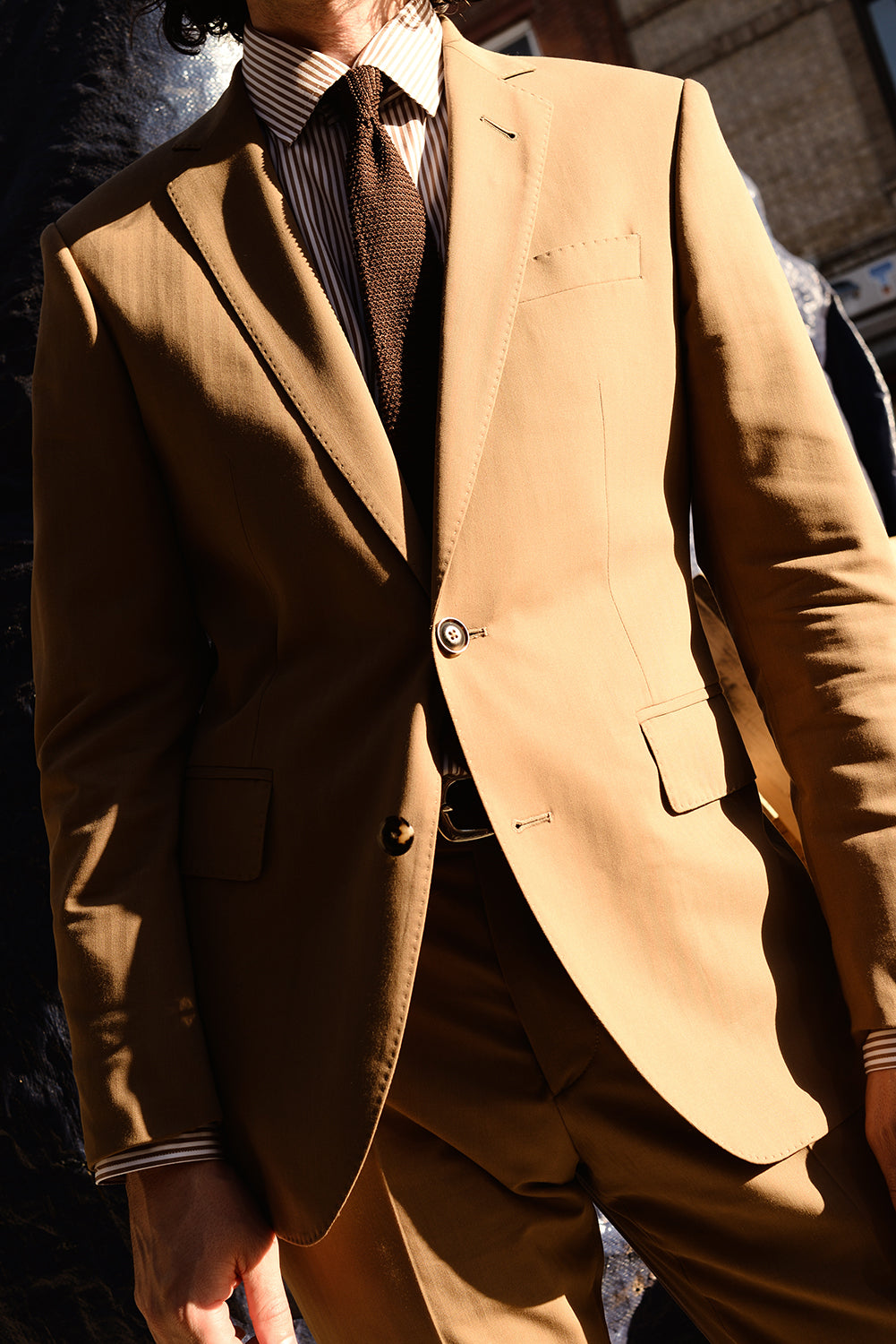 On-body shot of BKT50 Tailored Blazer in Herringbone Wool/Cotton - Tobacco. Model is wearing jacket with matching pant, striped dress shirt and knit tie