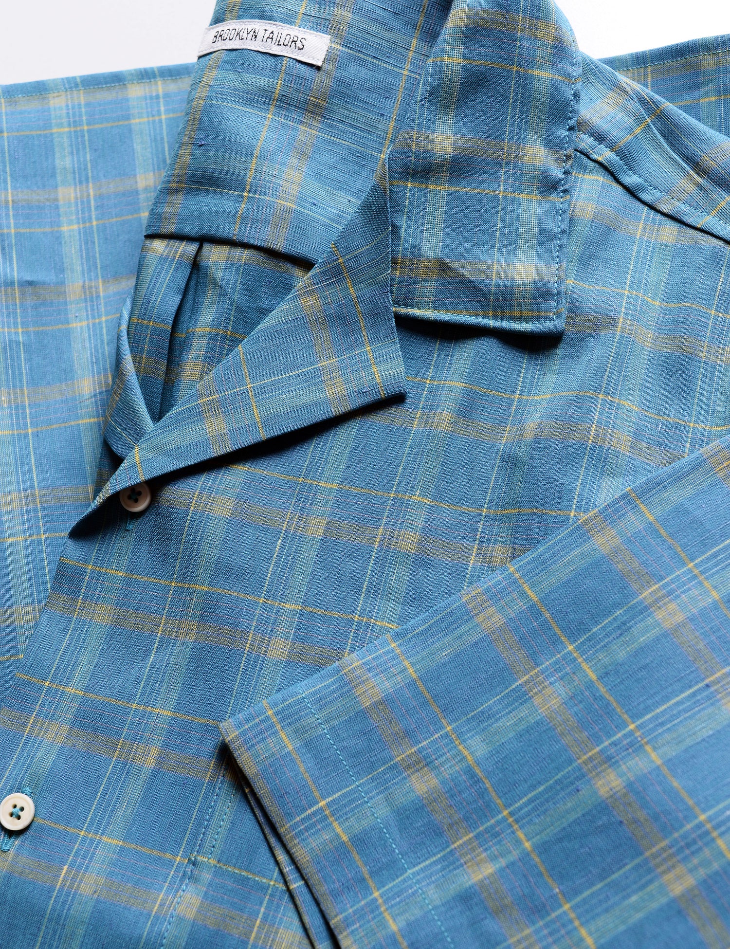 Detail shot of BKT18 Camp Shirt in Roman Check - Ionian Blue showing camp collar and sleeve
