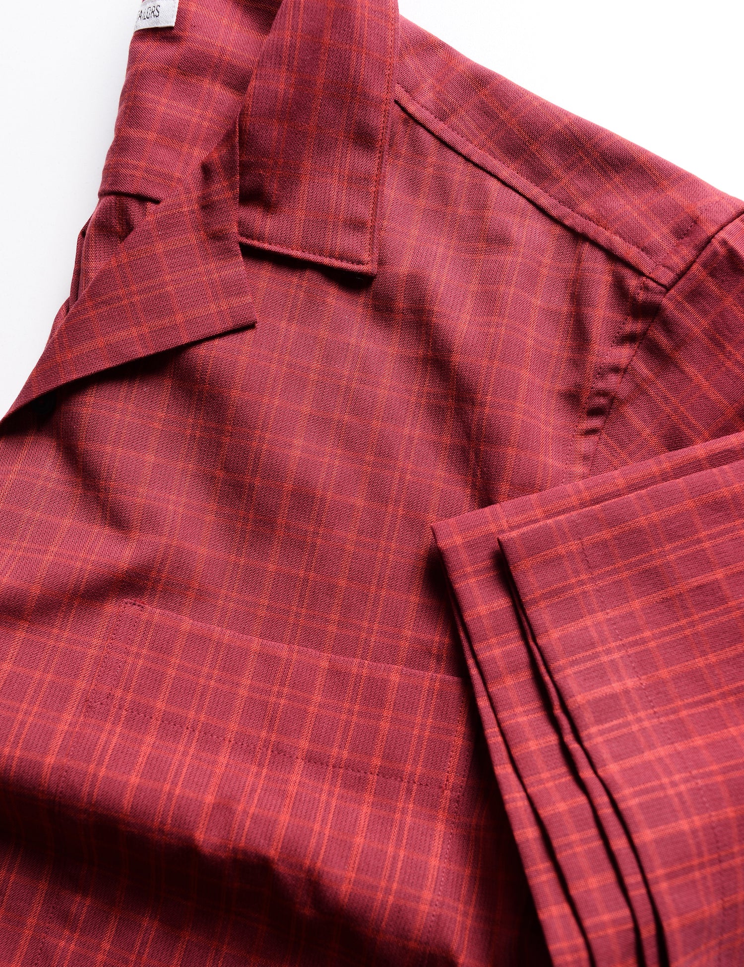 Detail of BKT18 Camp Shirt in Roman Check - Siena Red showing fabric pattern, camp collar, and sleeve