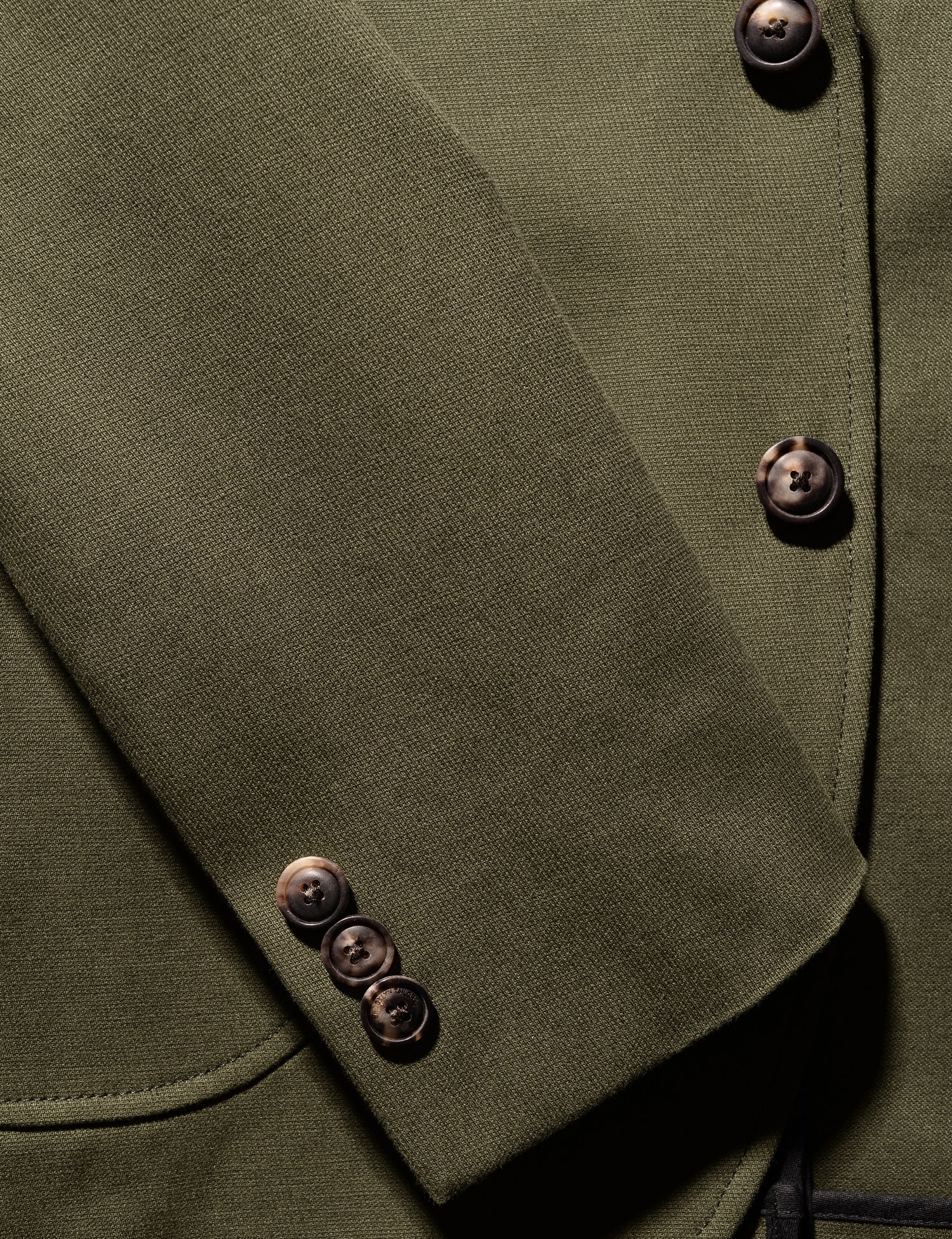 Detail shot showing cuff, patch pocket, buttons, and fabric texture on Brooklyn Tailors BKT35 Unstructured Jacket in Cavalry Twill - Olive