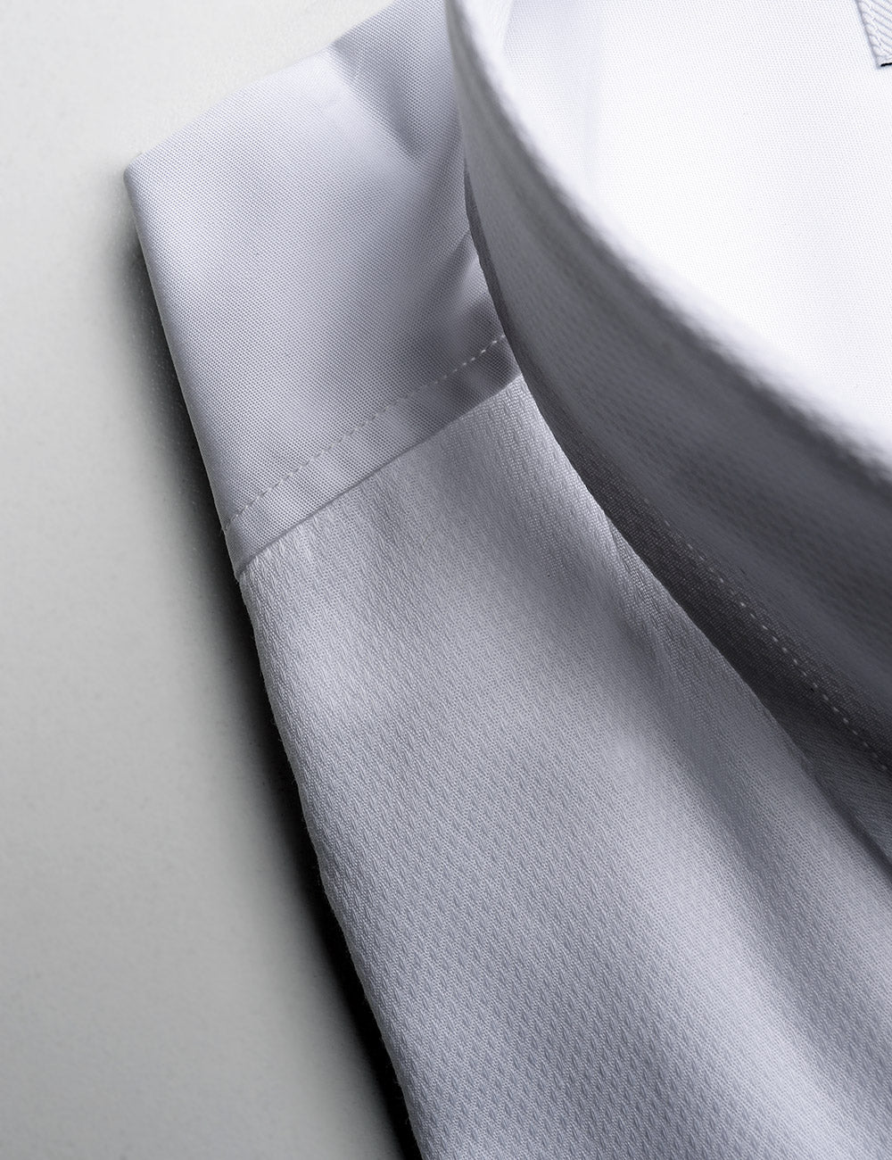 Close-up shot of French Cuff Tuxedo Shirt With Removable Buttons - White Dobby showing front fabric and back fabric