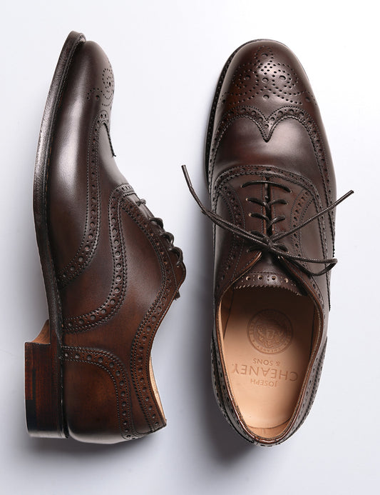 Photo of Joseph Cheaney Arthur III Oxford Brogue in Mocha Calf Leather. One of the shoes is on its side to show the profile.