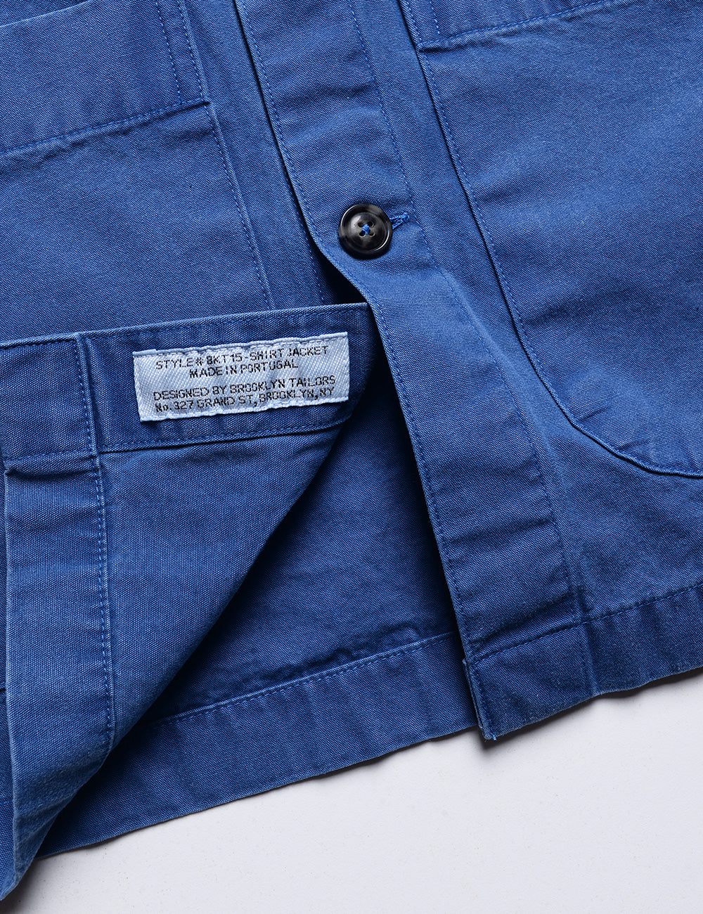 Detail shot of hem and interior labeling on Brooklyn Tailors BKT15 Shirt Jacket in Crisp Cotton - Washed Cobalt