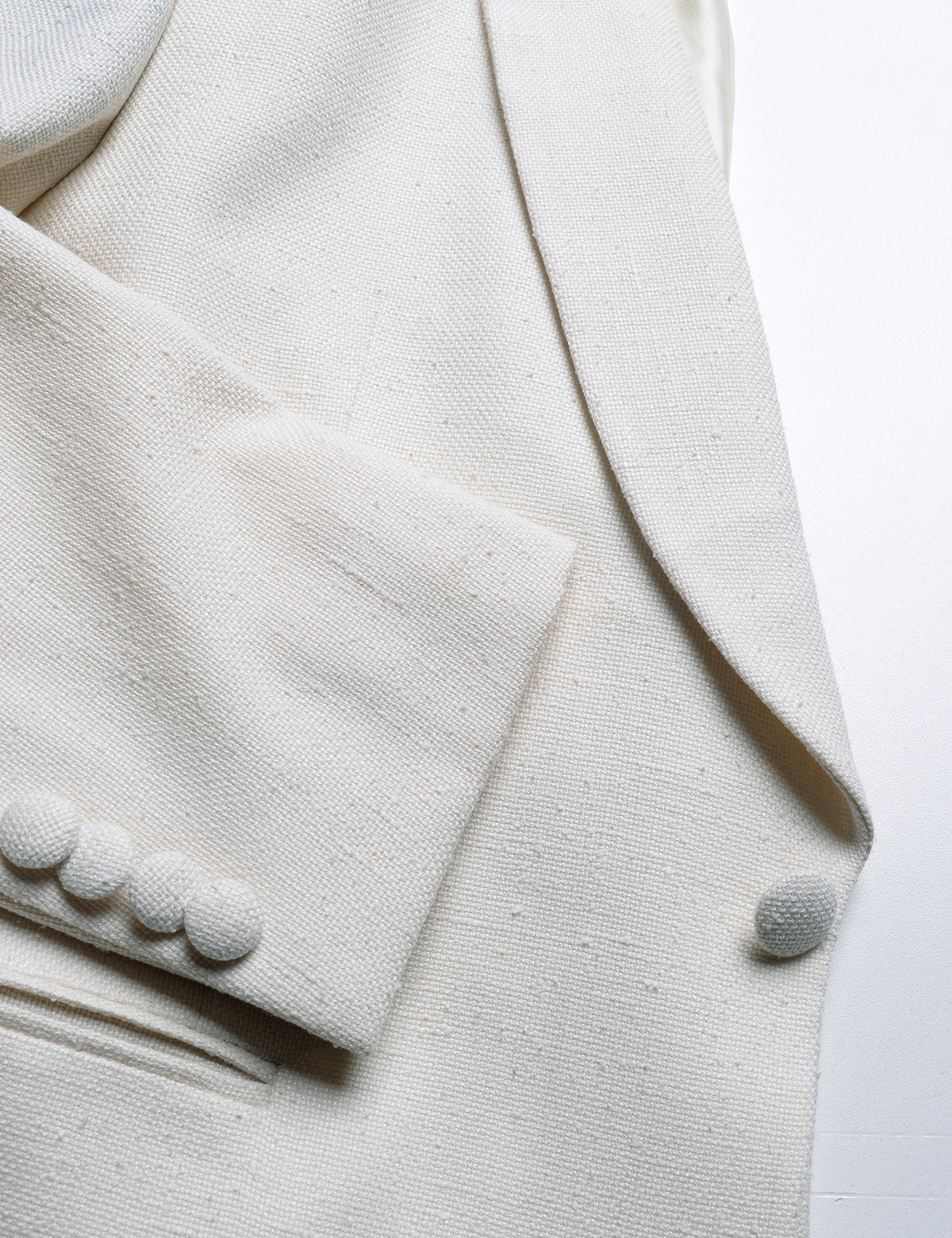 Detail shot of Brooklyn Tailors BKT50 Shawl Collar Dinner Jacket in Silk & Wool Hopsack - Ivory showing cuff, lapel and button