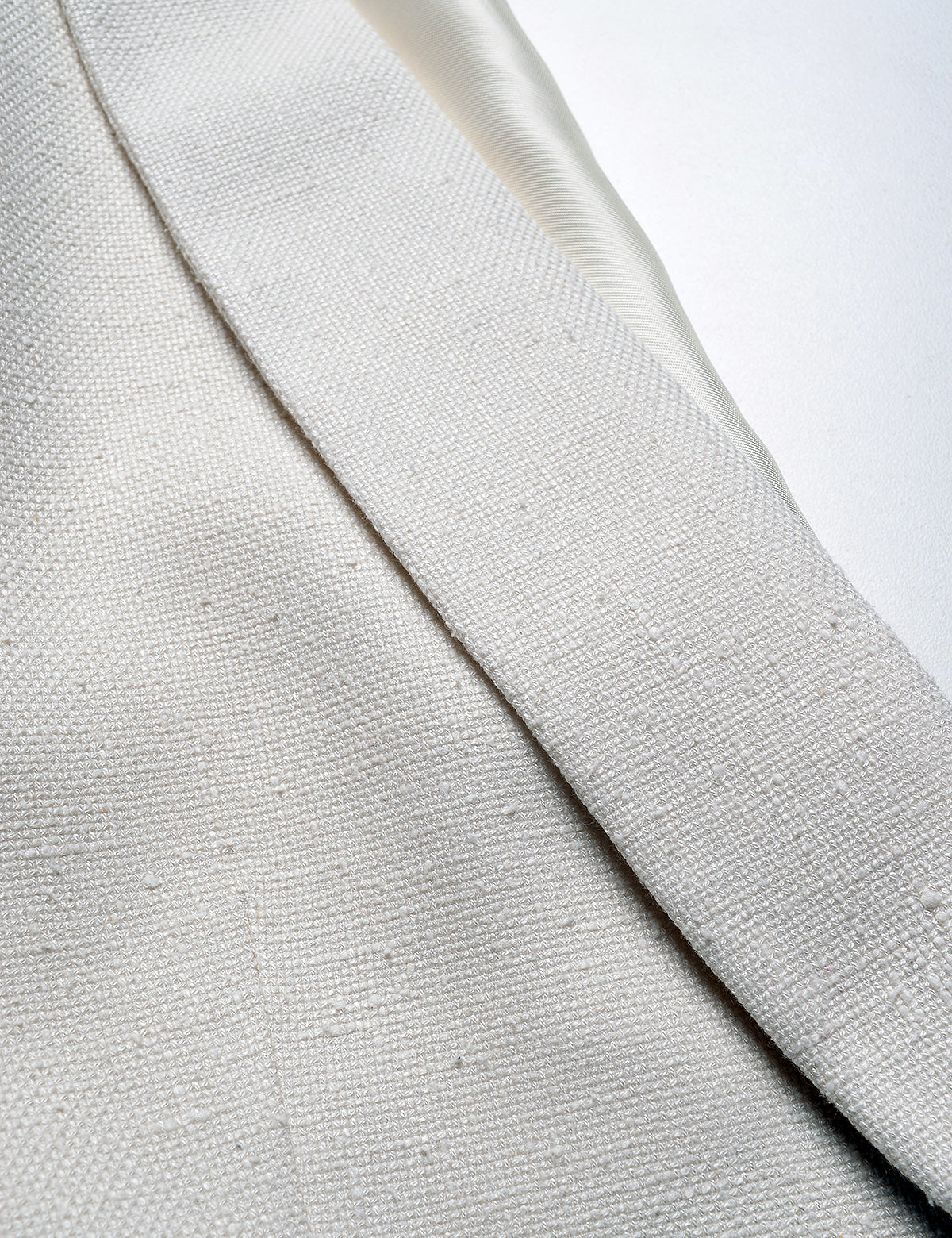 Detail shot of Brooklyn Tailors BKT50 Shawl Collar Dinner Jacket in Silk & Wool Hopsack - Ivory showing the lapel and fabric texture