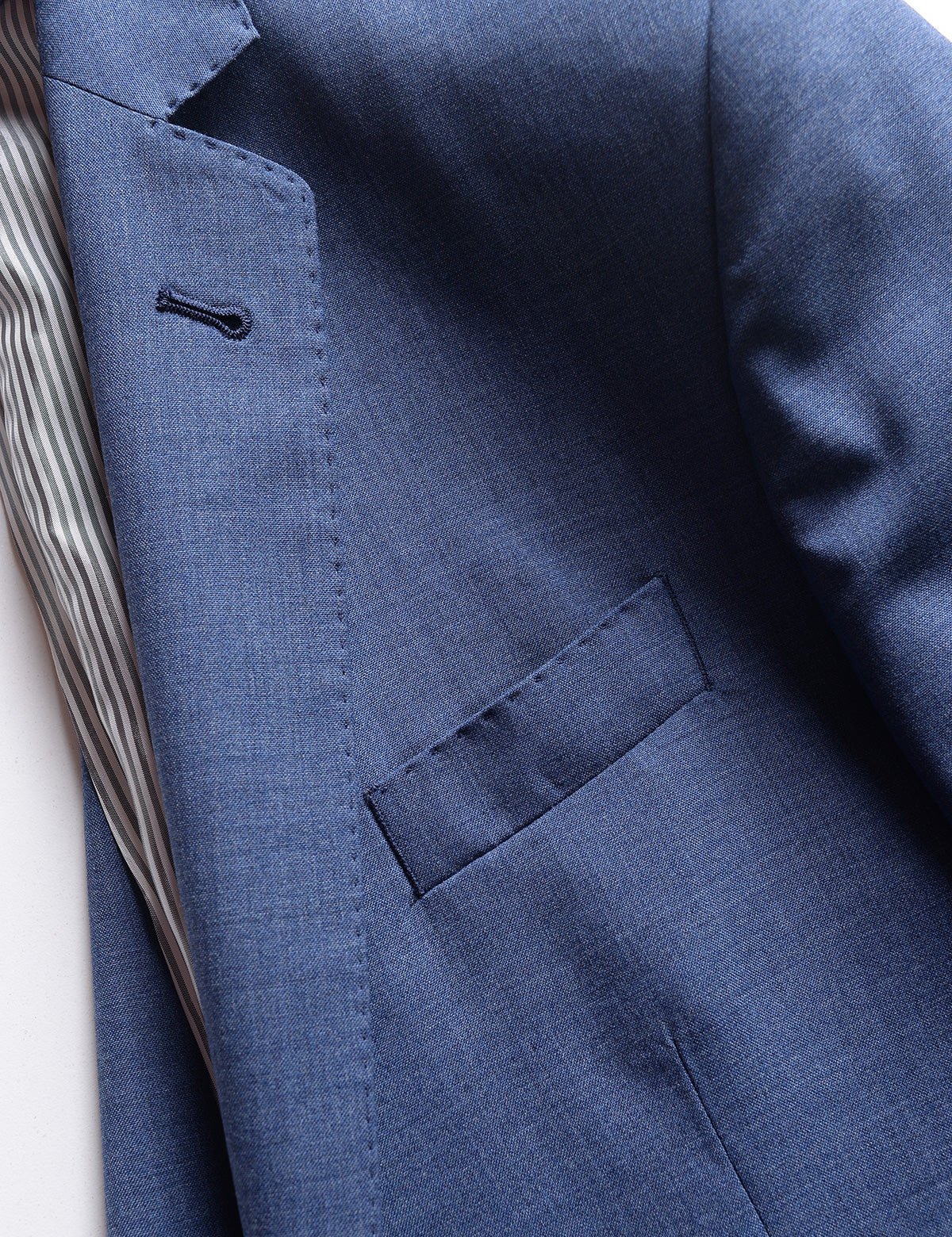 Detail shot of Brooklyn Tailors BKT50 Tailored Jacket in Heathered Wool - San Marino Blue showing lining, lapel, chest pocket, and fabric texture