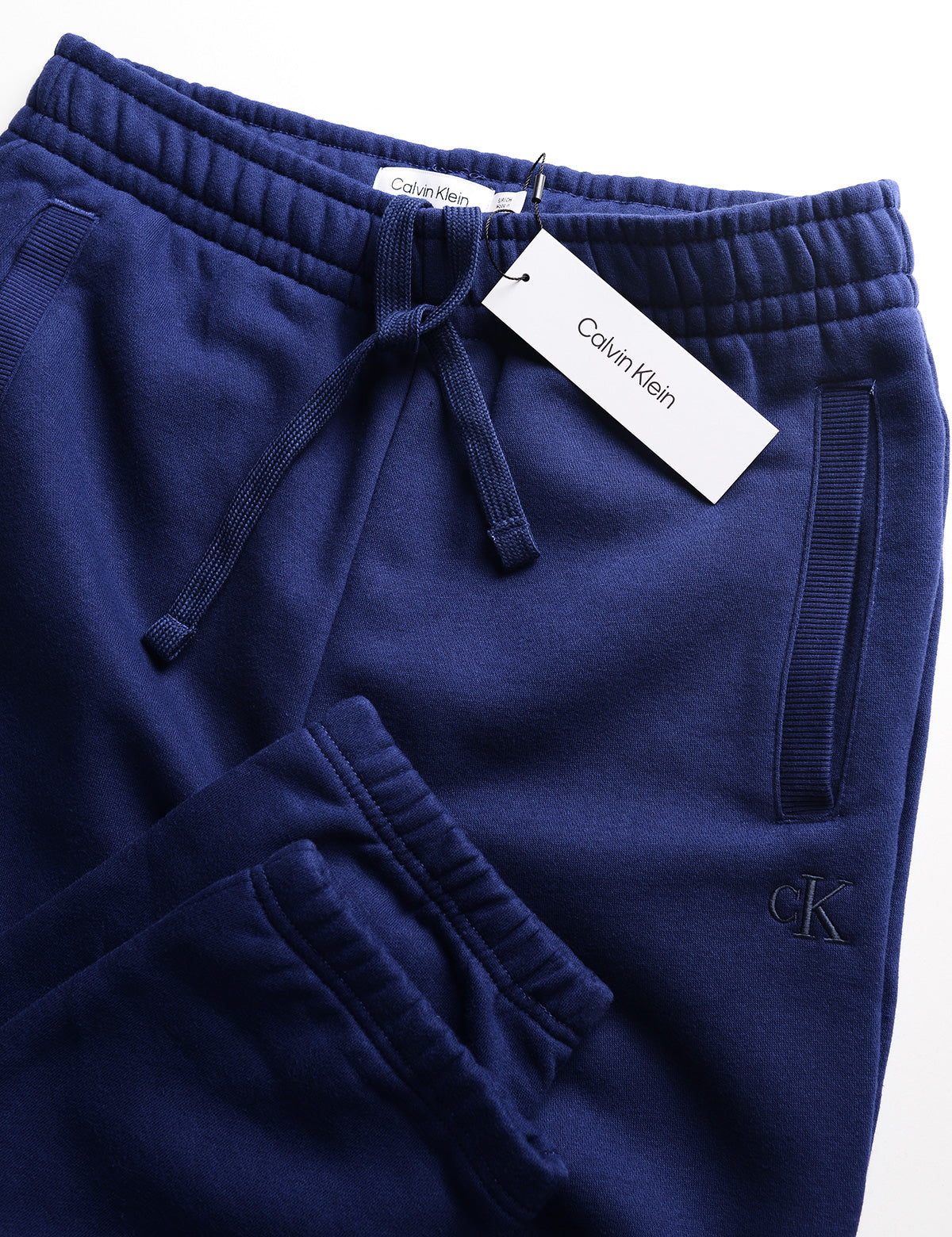 Detail of the waist, pocket, and cuff of the Calvin Klein Archive Logo Fleece Jogger - Beacon Blue