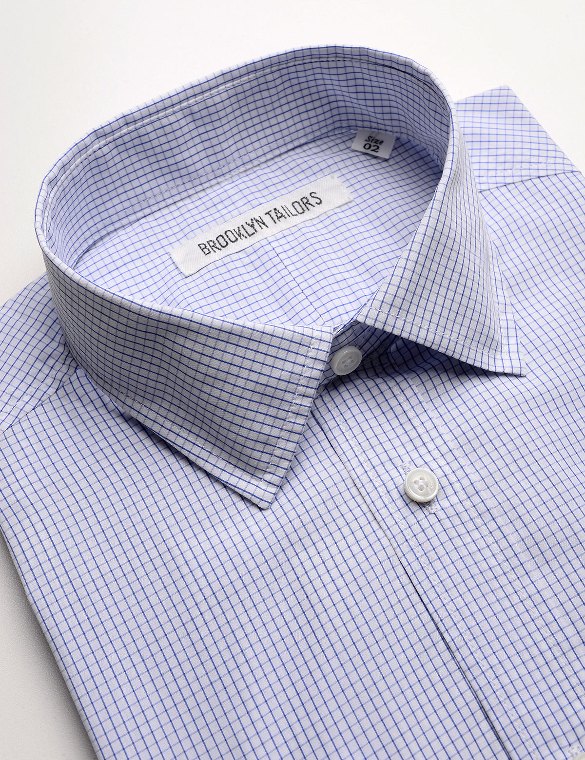 Detail shot of collar, fabric pattern, and buttons on Brooklyn Tailors BKT20 Slim Dress Shirt in Graph Check - White & Blue
