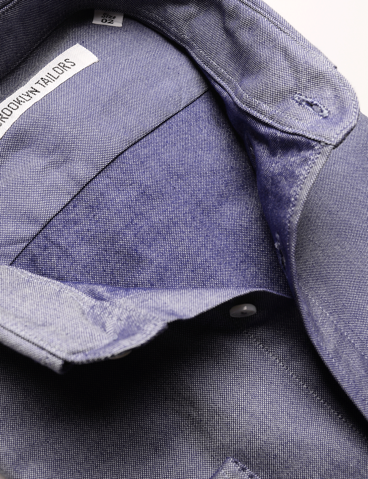 Detail shot of Brooklyn Tailors BKT10 Slim Casual Shirt in Fall Oxford - Deep Blue open collar showing interior fabric texture