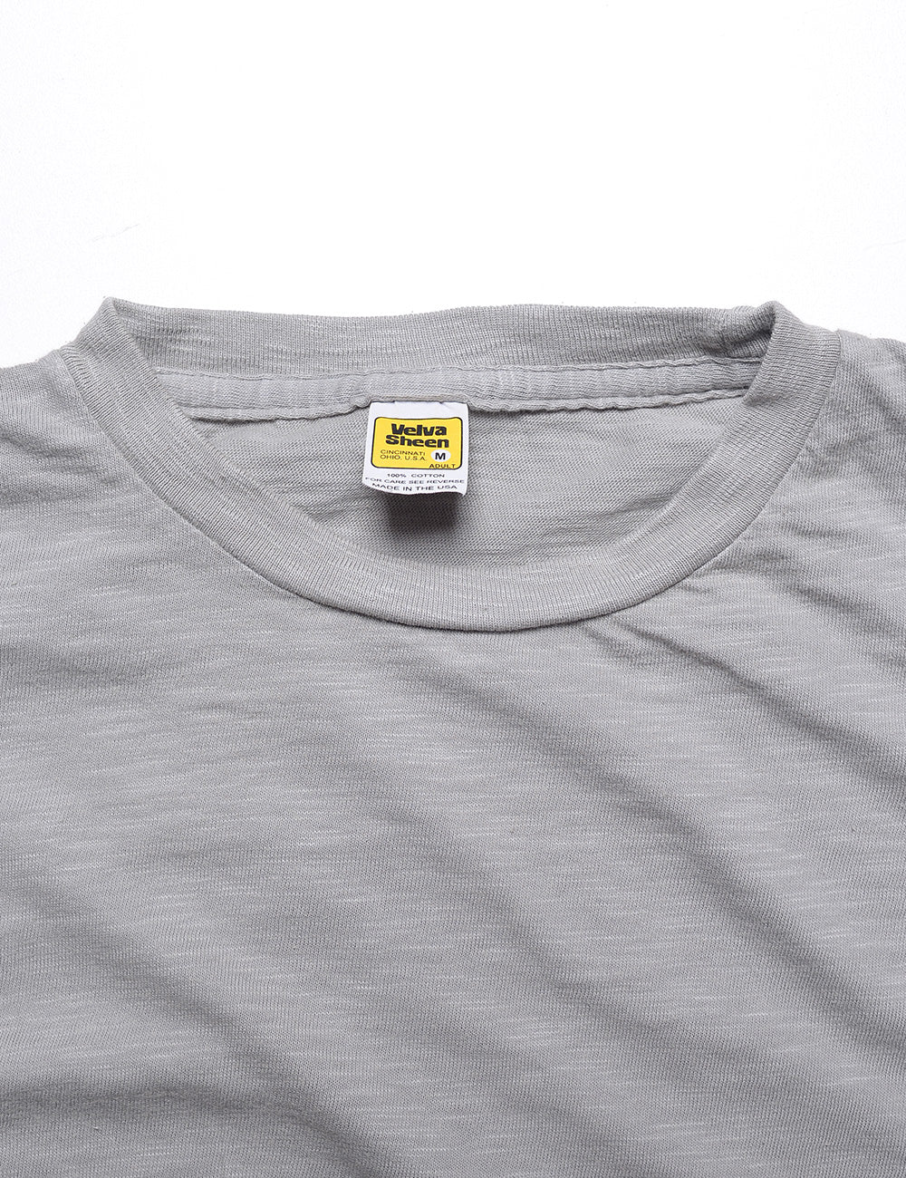 Close-up shot of Velva Sheen Crewneck T-Shirt in Concrete showing crewneck and label