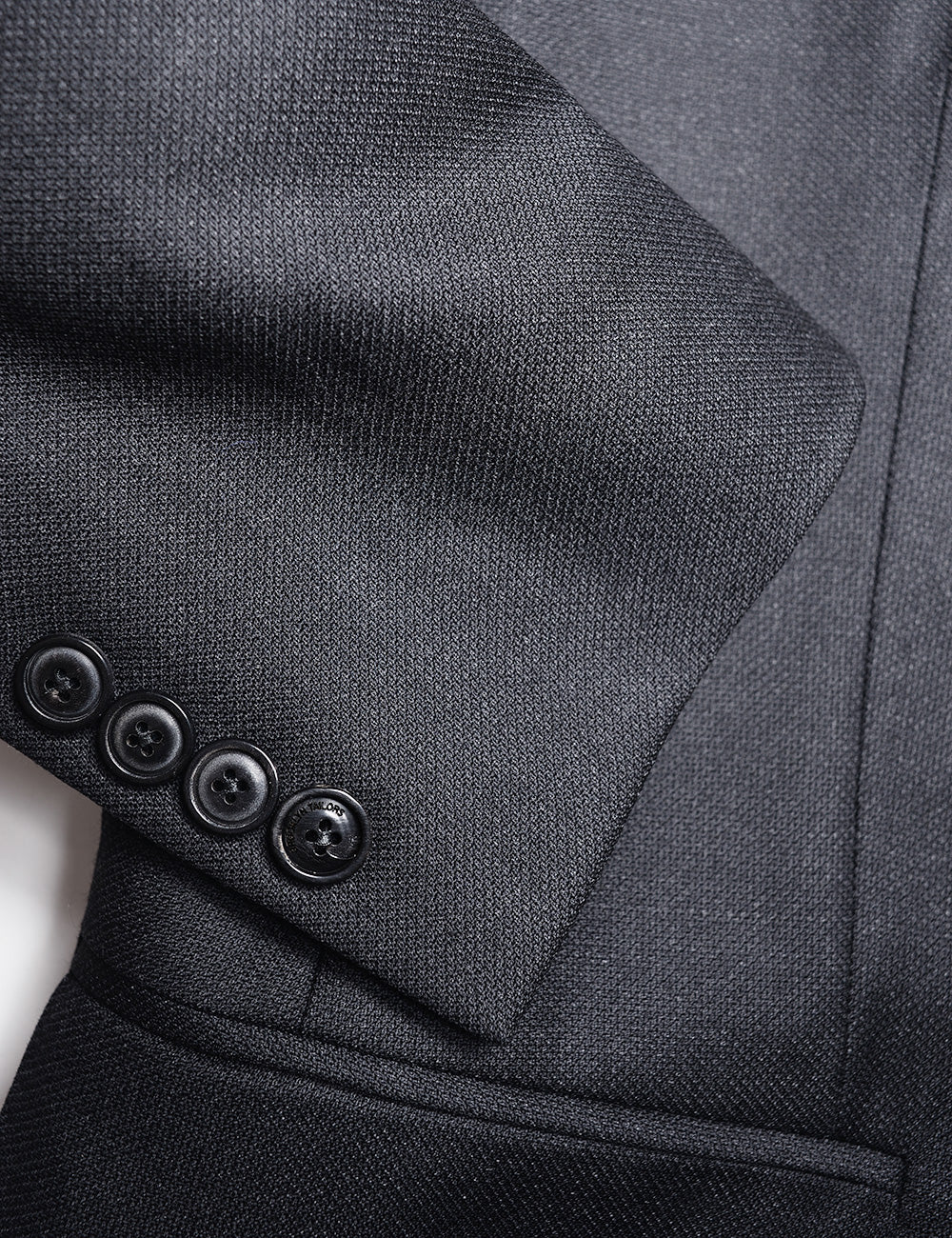Detail of BKT50 Tailored Jacket in Birdseye Weave - Black showing fabric texture and cuff