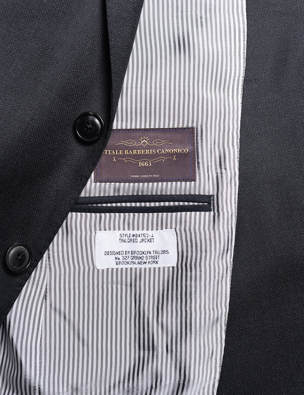 Detail of BKT50 Tailored Jacket in Birdseye Weave - Black showing lining and labeling
